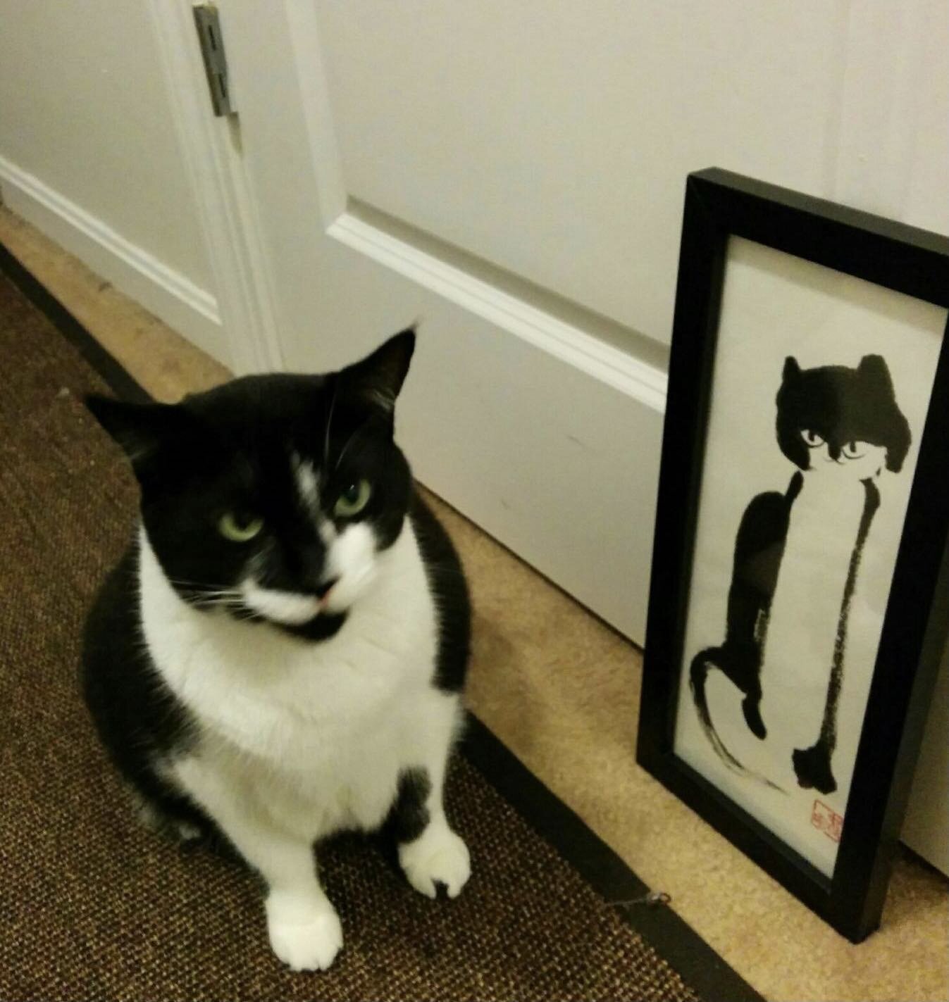 The cat &ldquo;Pepper&rdquo; finally approved my painting of him.  Years ago, a man came into my open studio and brought this Sumie painting of a cat, just now by surprise, I got the photo.  It made my day!

Don&rsquo;t you love surprise?  Can you sh