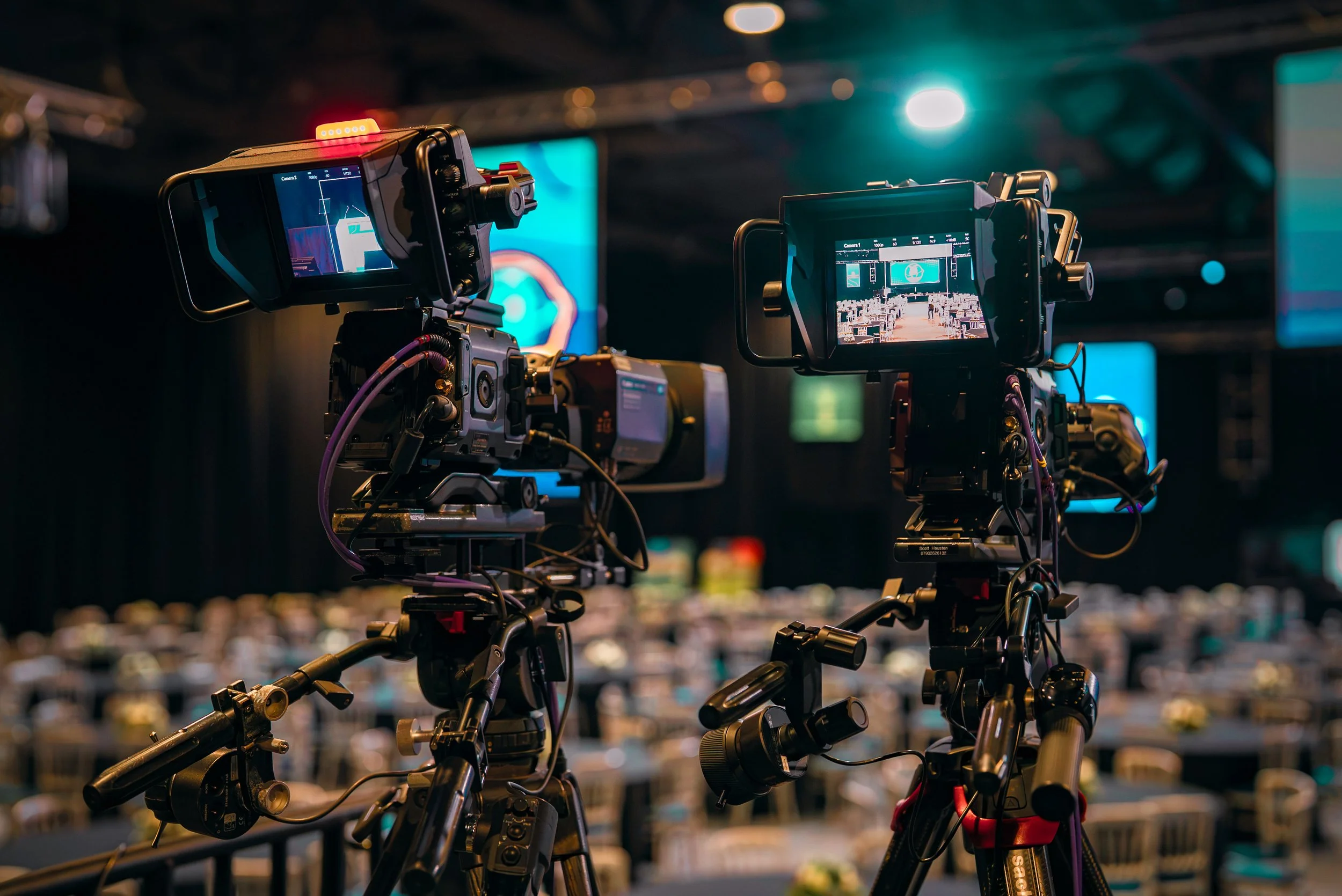Two Blackmagic URSA Broadcast G2 cameras with studio monitors at a live event