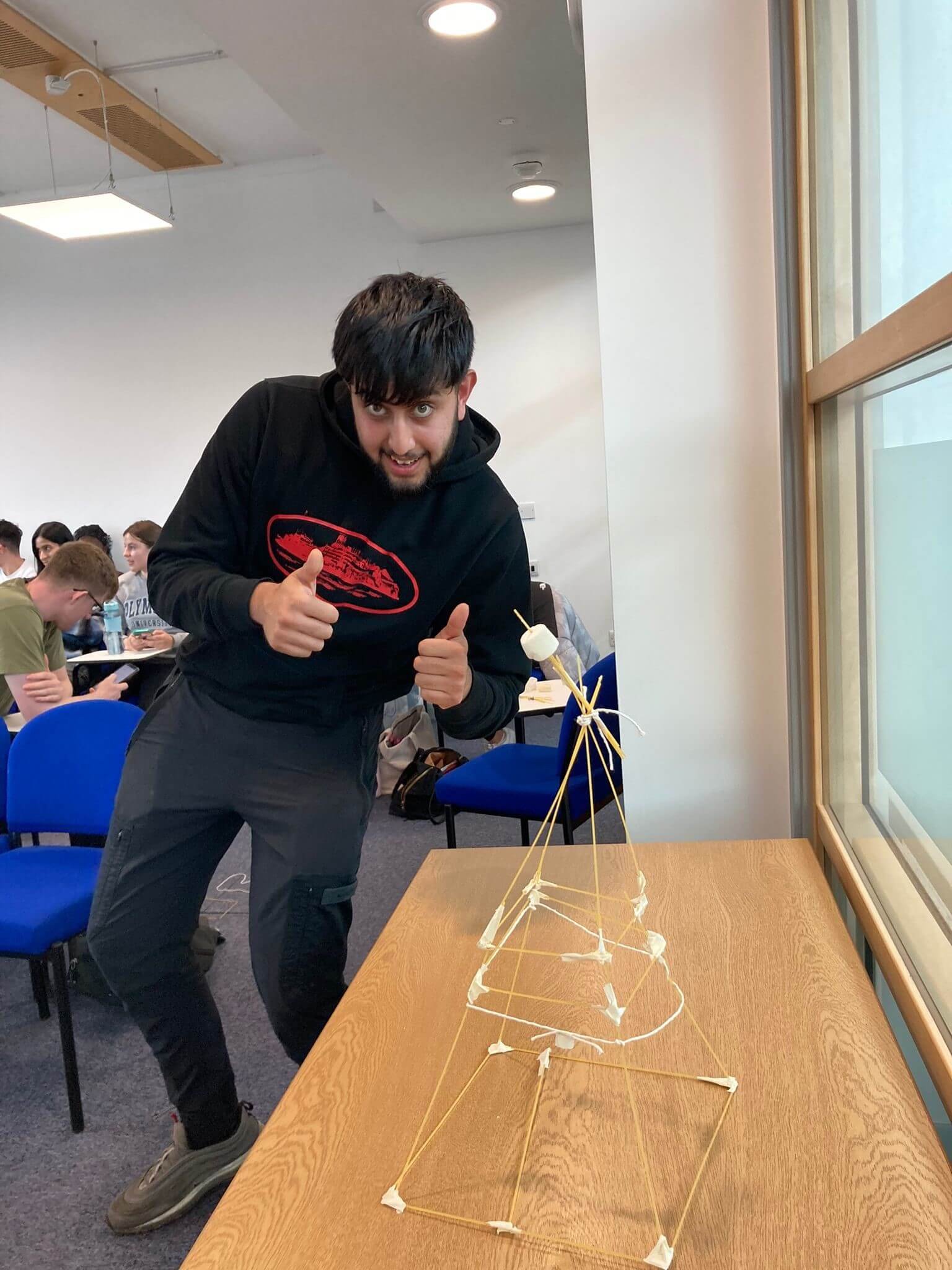 Student with spaghetti tower.