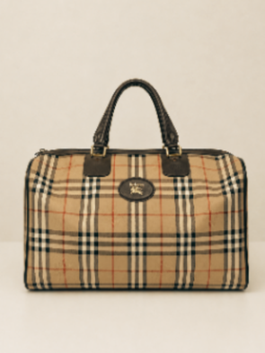 A beige handbag with a nova check pattern, black handles, and a gold emblem on the front.