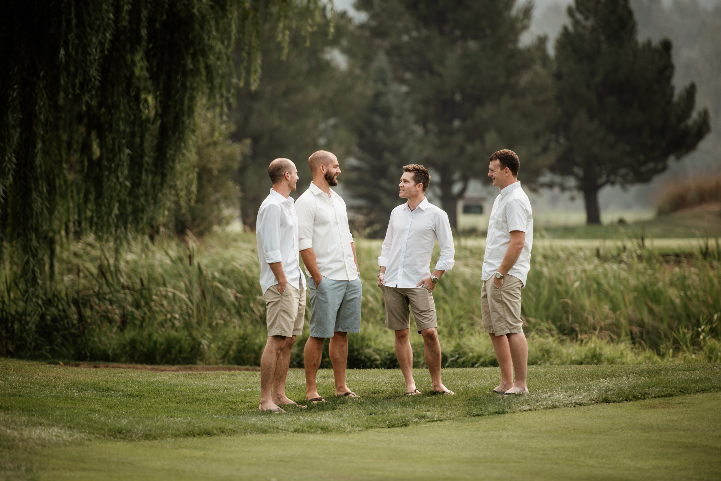 Groomsmen chatting at a wedding at Big Sky Golf course in Pemberton