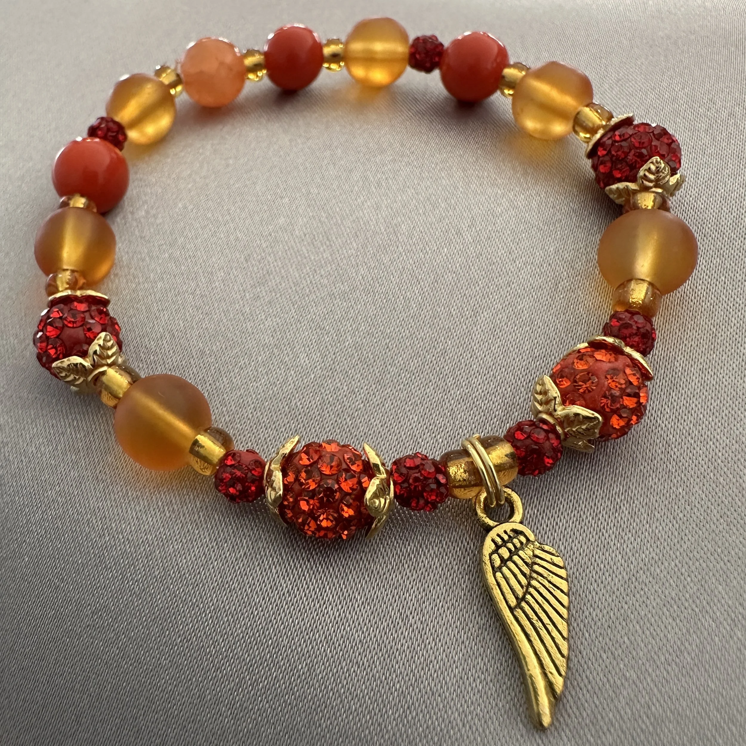 Orange, Red and Gold Beaded Bracelet W/Angel Wing Charm