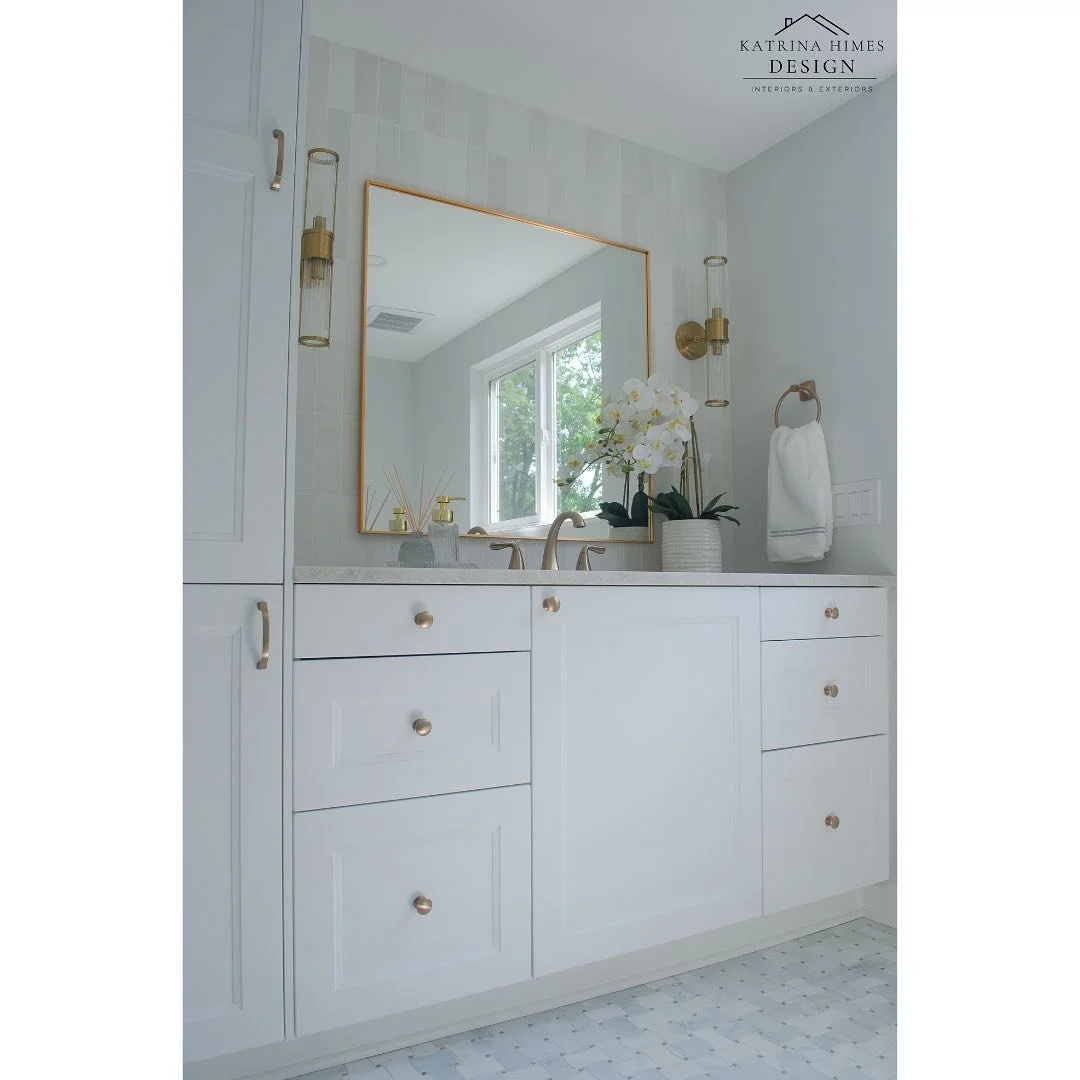 Vanity wall focal point featuring elegant wall tiles, chic sconce lighting, luxurious gold finishes, custom cabinetry, and exquisite marble countertops. This bathroom remodel epitomizes sophistication and style.

Design &amp; 📷: Katrina Himes Design