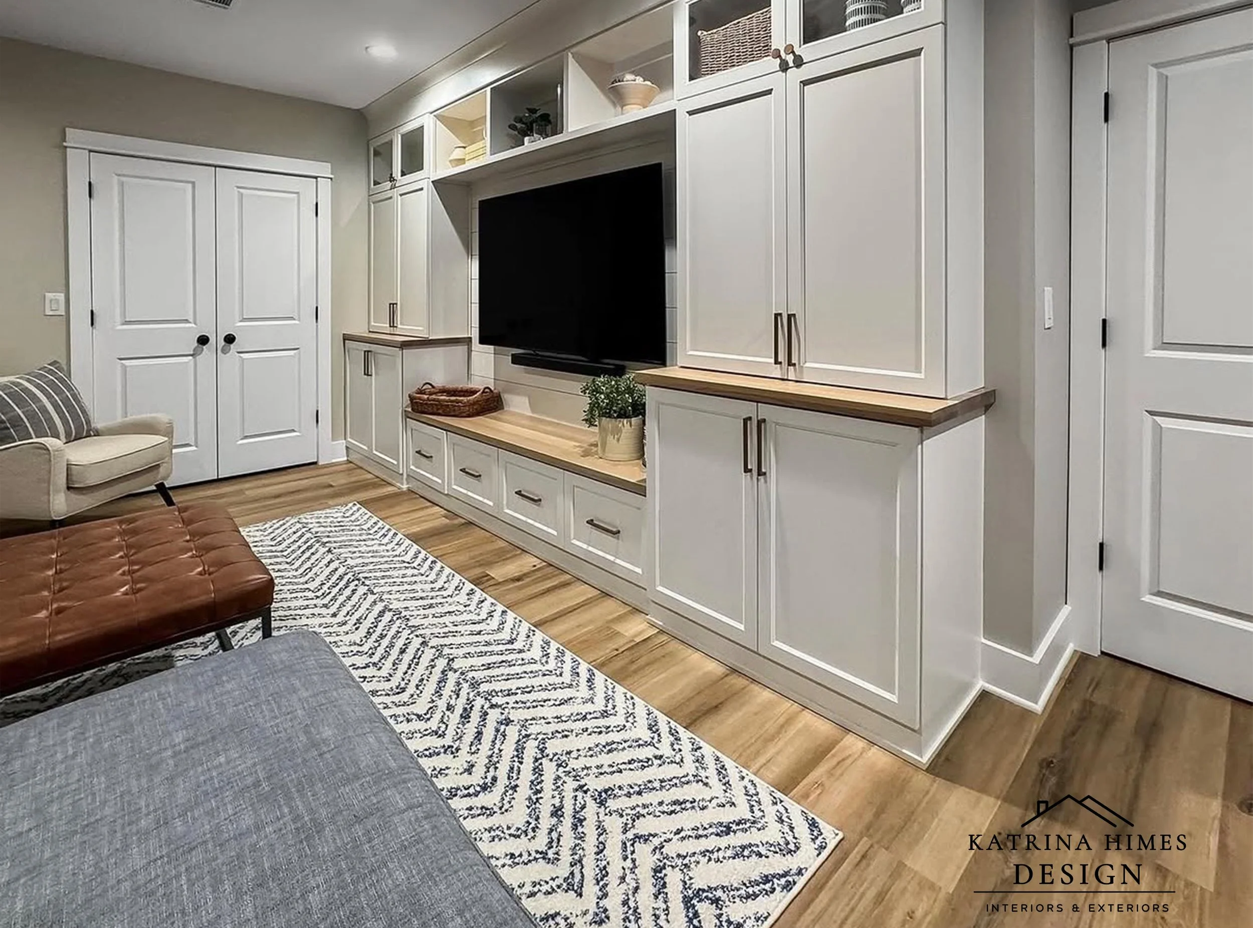 Custom basement entertainment wall with built-in cabinetry in Royal Oak Michigan