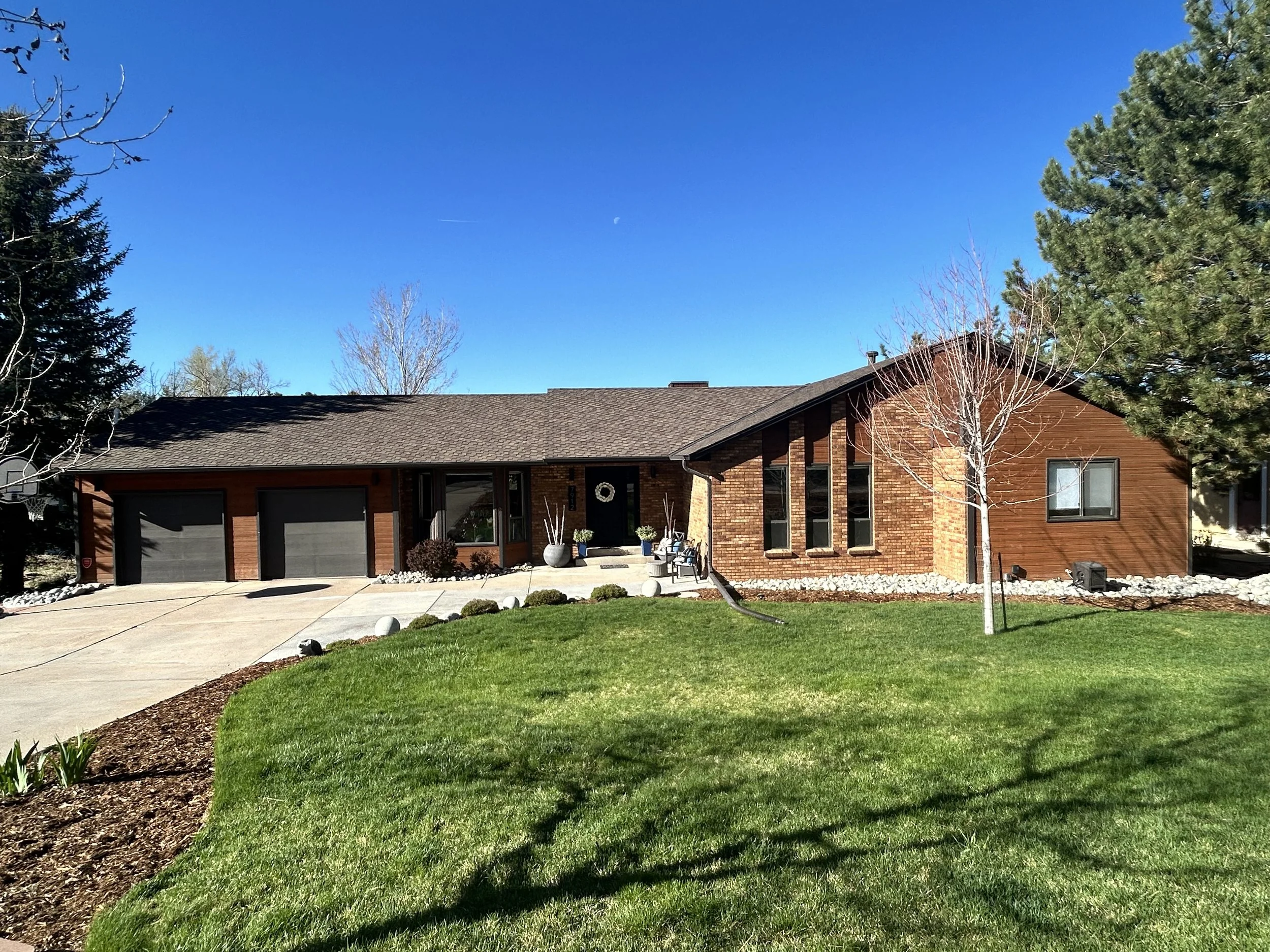 Before exterior of wood sided home in Parker Colorado