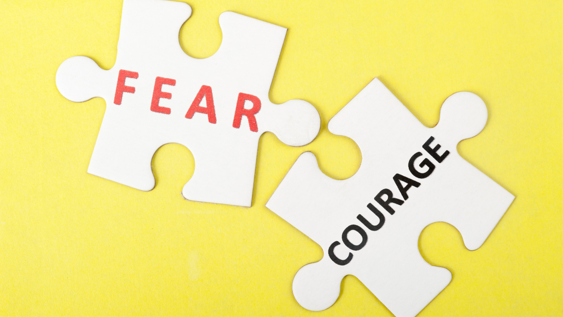 puzzle pieces that have the words fear and courage