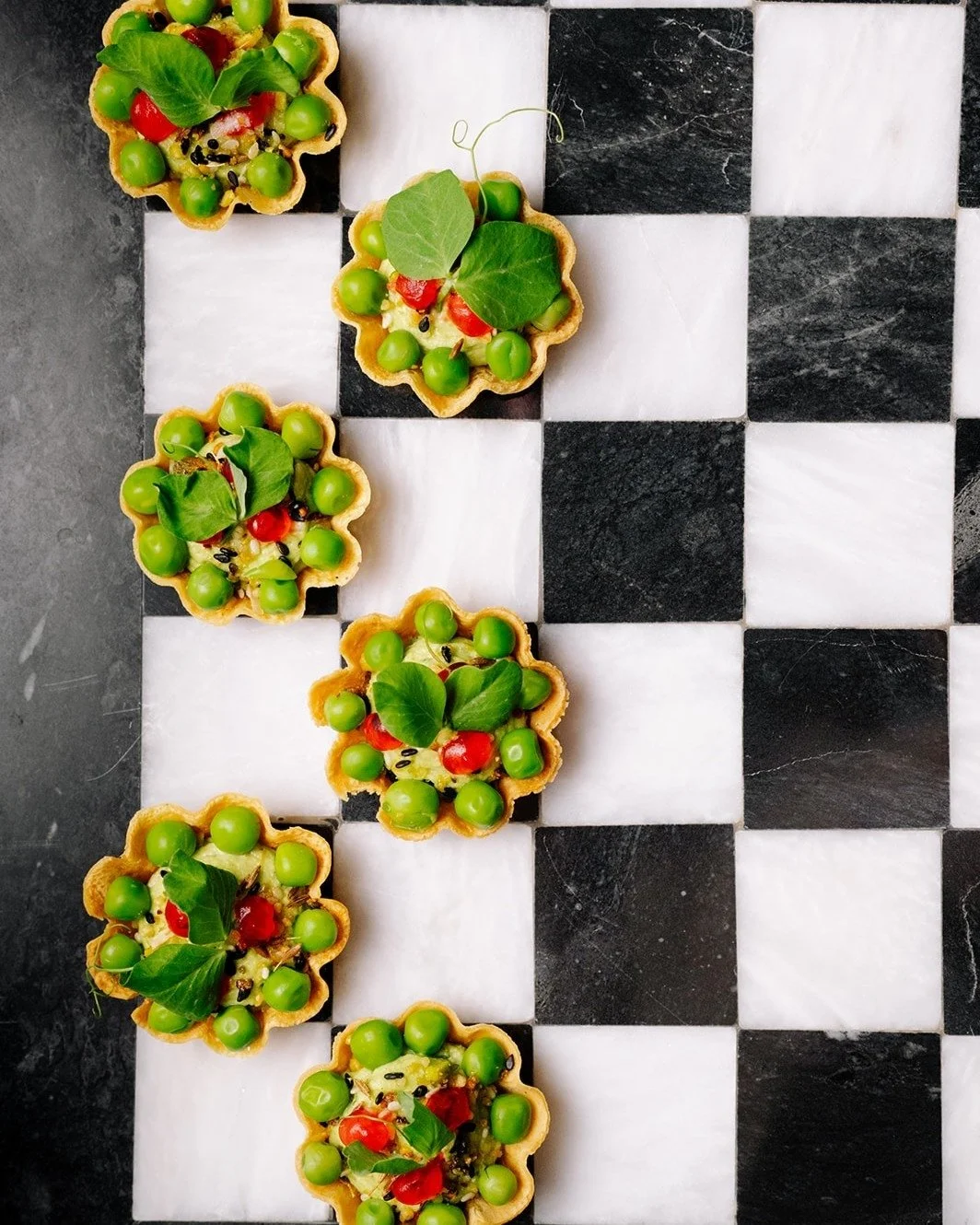 ✨ Meet your new plant-based crush ✨ ​​​​​​​​
Our Chickpea Tart is serving up layers of vegan goodness: curried green peas, creamy garlic hummus, juicy pops of pomegranate, a sprinkle of pistachio dukkah, and a burst of fresh mint + micro cilantro. 🌱