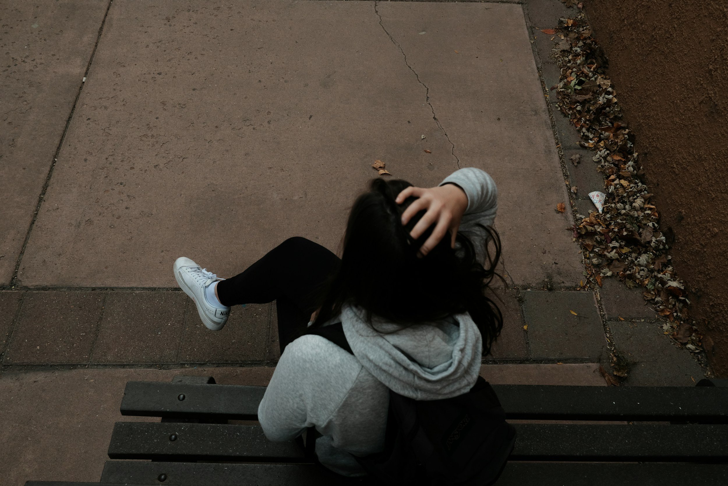 Woman sitting on a bench in Austin needing trauma therapy