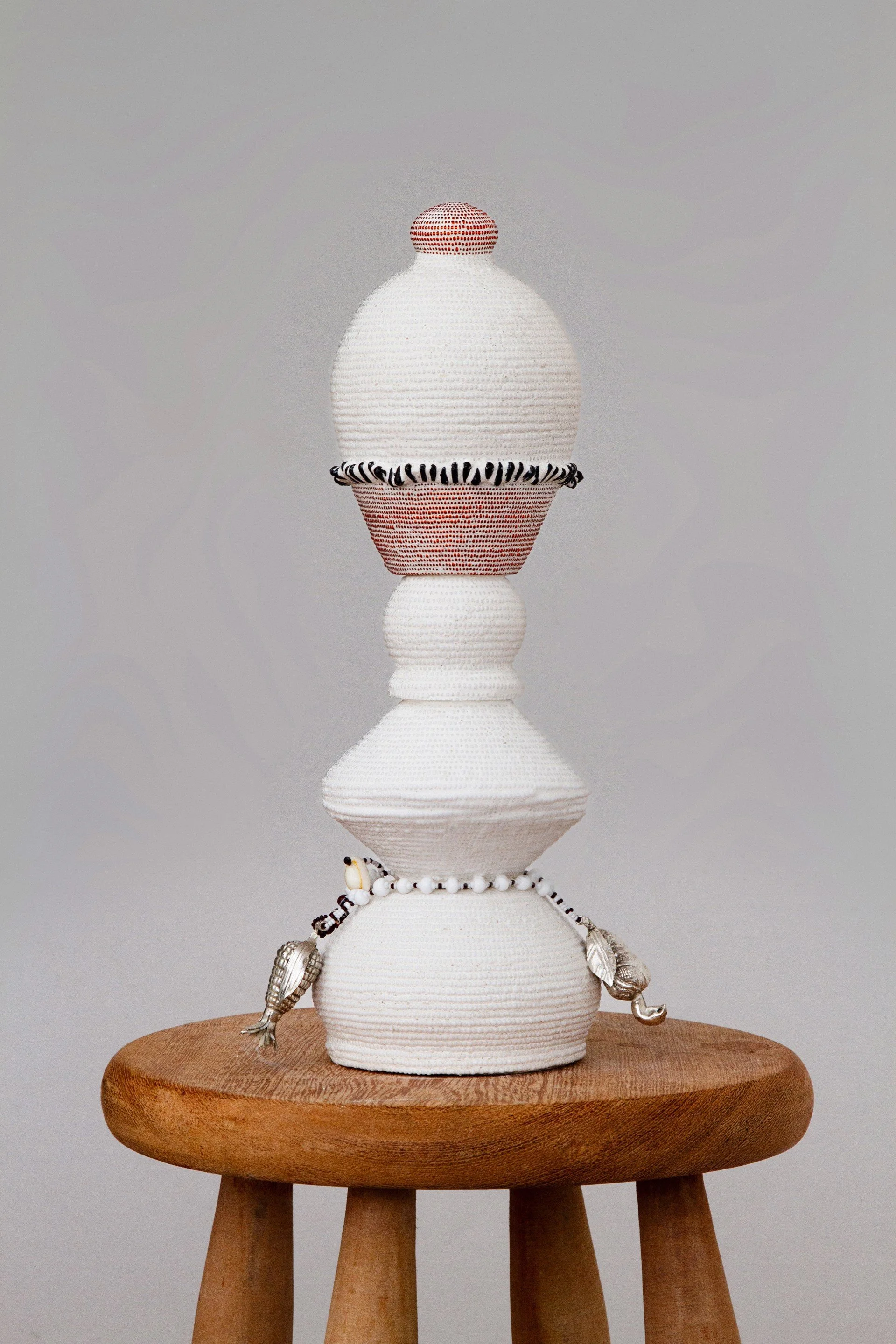 Pedaço da Penca II, 2026 Glass beads, gourd, ceramic, brass, silver-plated balangandã elements, clay (Durban, South Africa; Santa Rita Quilombo Area, Maranhão, Brazil)  35 x 10 cm (13.78 x 3.94 in), Luma Nascimento