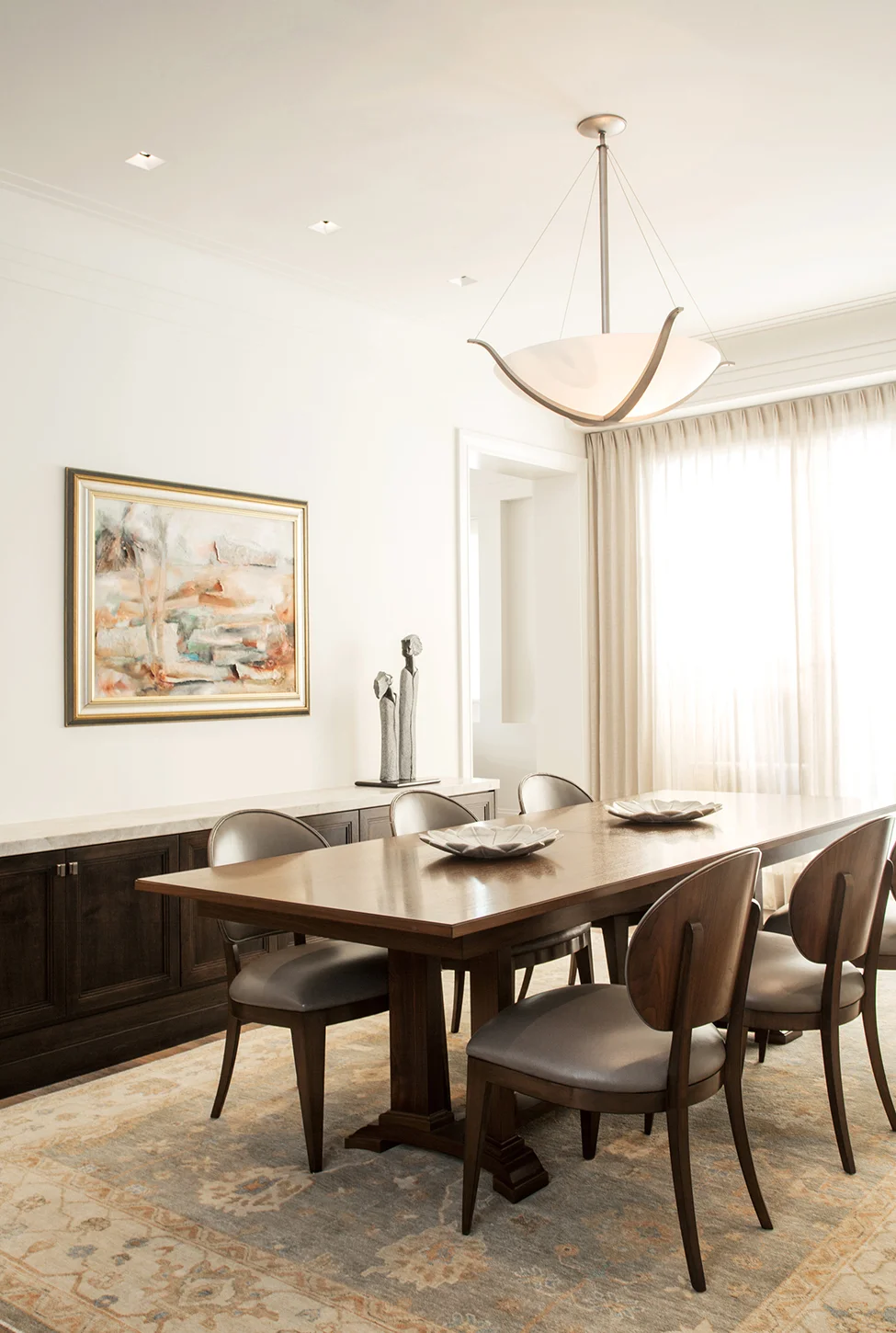 Traditional formal dining room with wood furniture and patterned area rug