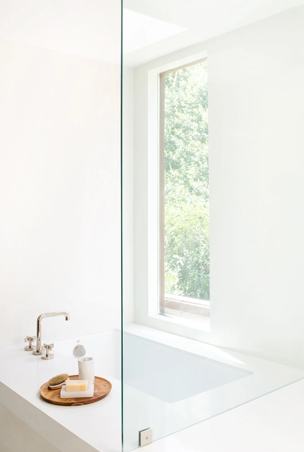 Bright and white modern Beverly Hills bathtub and glass enclosed shower