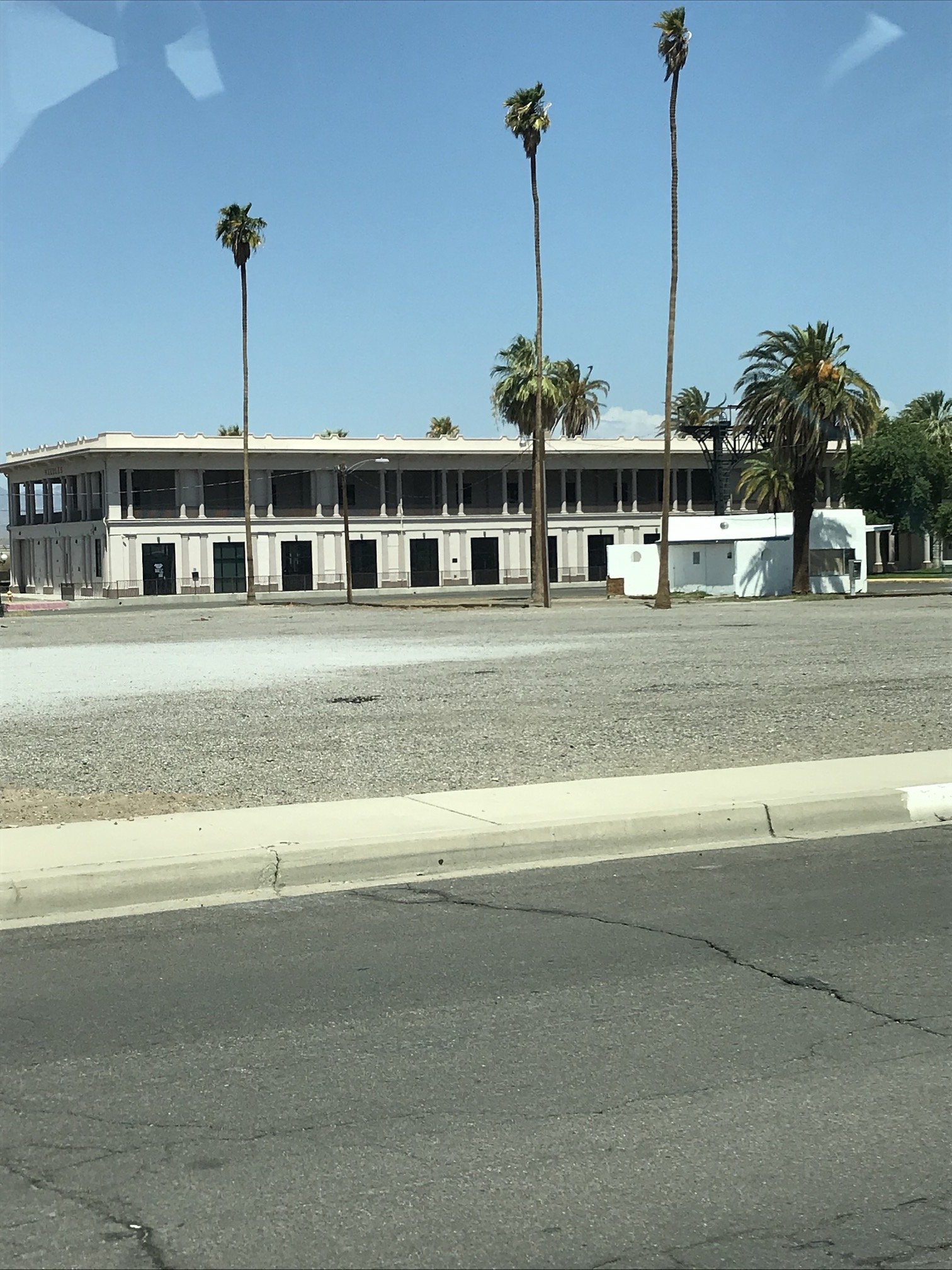  △   El Garces, one of the few remaining Harvey House hotels, deserted but still standing at Needles train station in the wicked-hot Mojave wind. Ghosts of the Atchison, Topeka &amp; Santa Fe Railway (now BNSF) and the Harvey Girls who helped open th