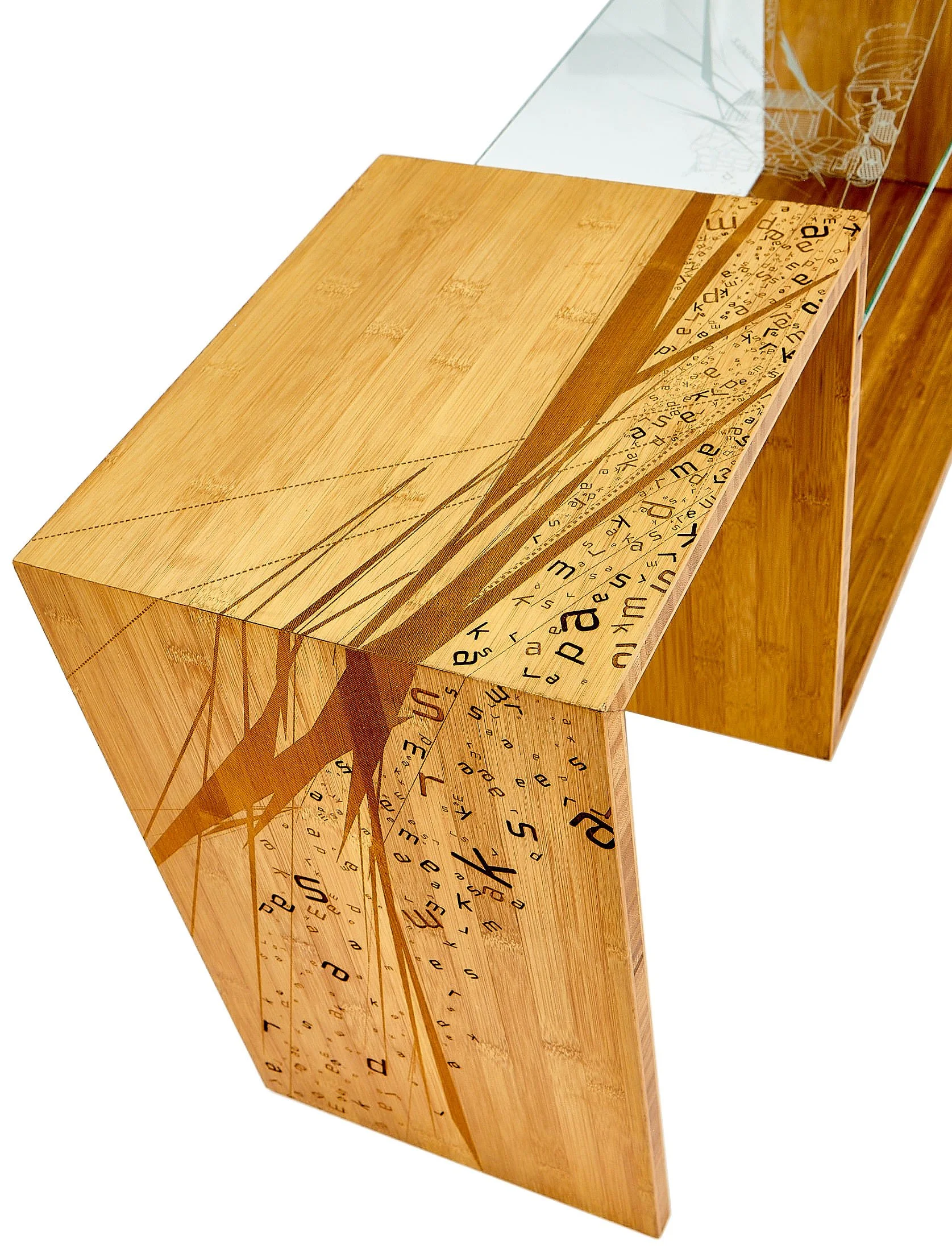 A wooden table with a decorative design of a tree and scattered letters, sitting on a wooden floor.
