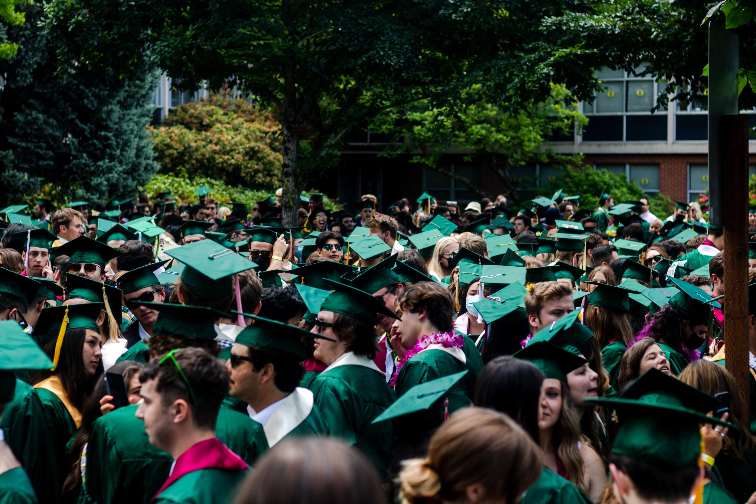 University of Oregon graduates gather outside of Hamilton Hall before the parade begins. After a full academic year of online school, the class of 2021 participated in the University of Oregon's traditional Grad Parade on June 12, 2021. (Will Geschk