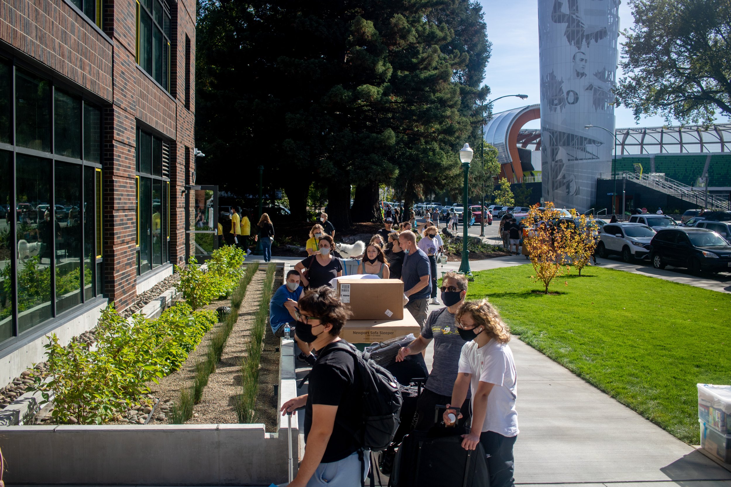University of Oregon students and their families stand in lengthy lines to enter Unthank hall on move in day, September 23, 2021. University of Oregon students are preparing to resume in person activities across campus during fall term. (Will Geschke