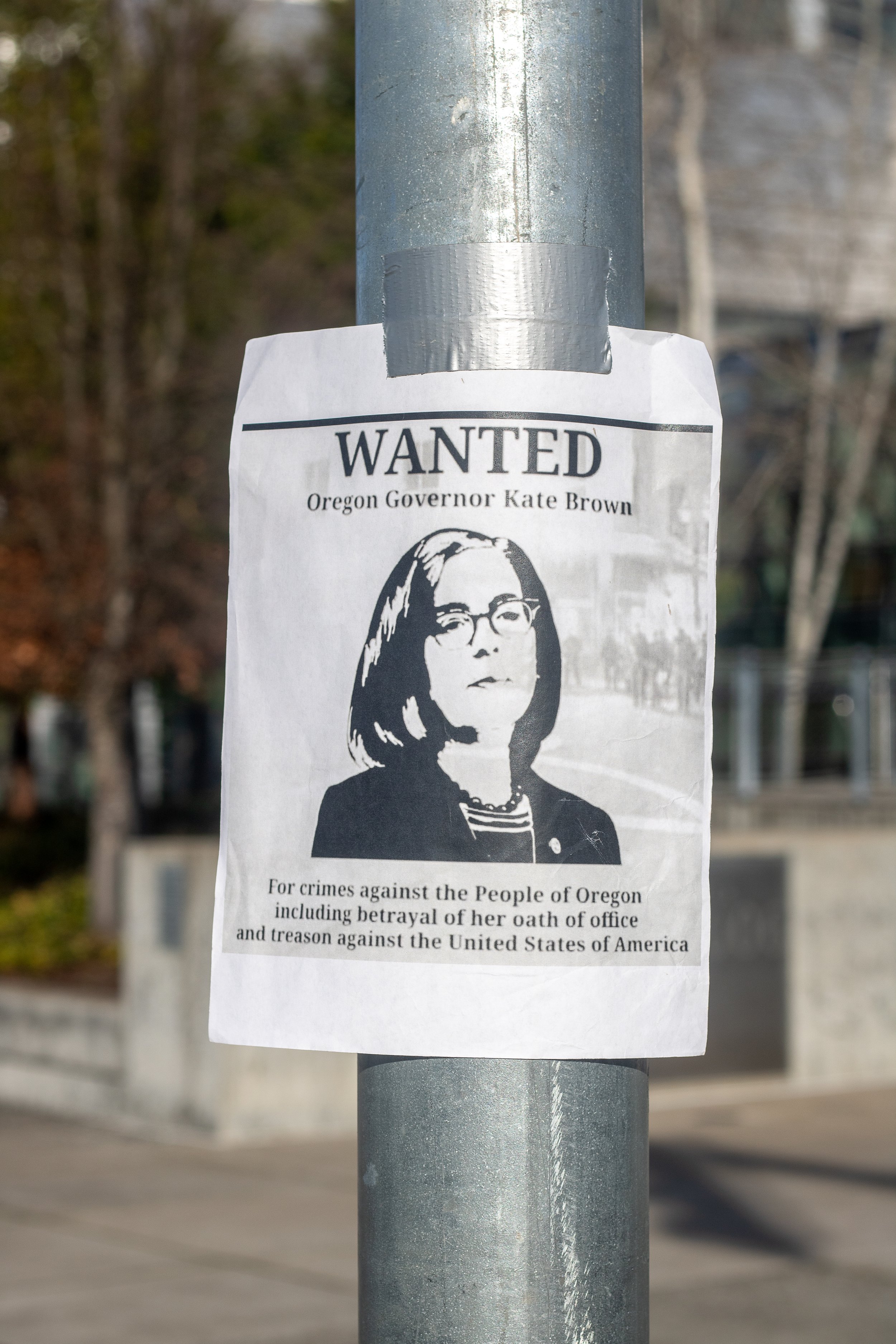 A makeshift wanted sign targeting Oregon governor Kate Brown hangs on a pole outside of the Eugene Federal Courthouse. A pro-Trump rally was held at Wayne Morse United States Courthouse in Eugene, Ore., on Jan. 9, 2021, in response to the riot that t