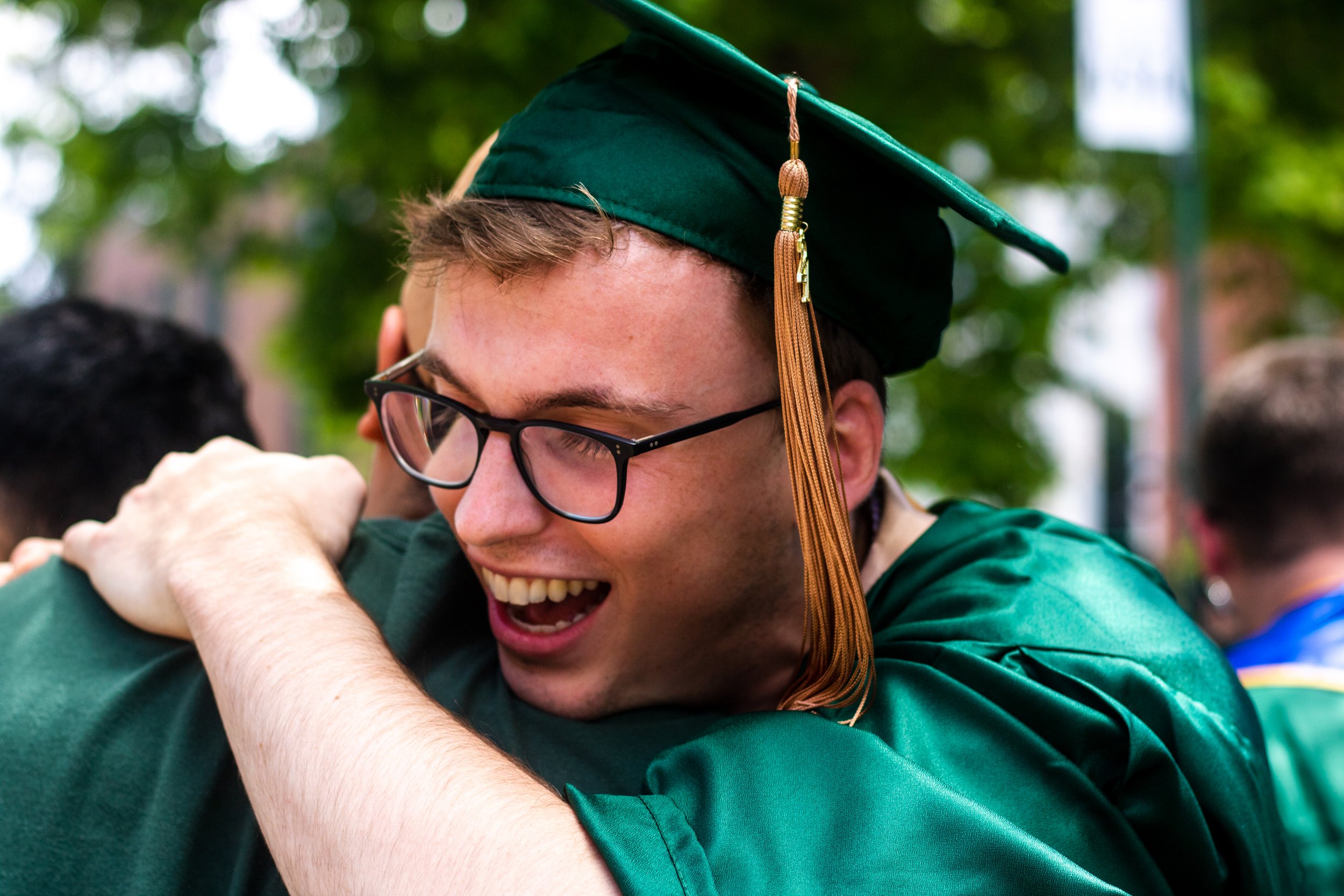 Tanner Brown, a graduate from the University of Oregon, embraces a member of the crowd during the Grad Parade. After a full academic year of online school, the class of 2021 participated in the University of Oregon's traditional Grad Parade on June 1
