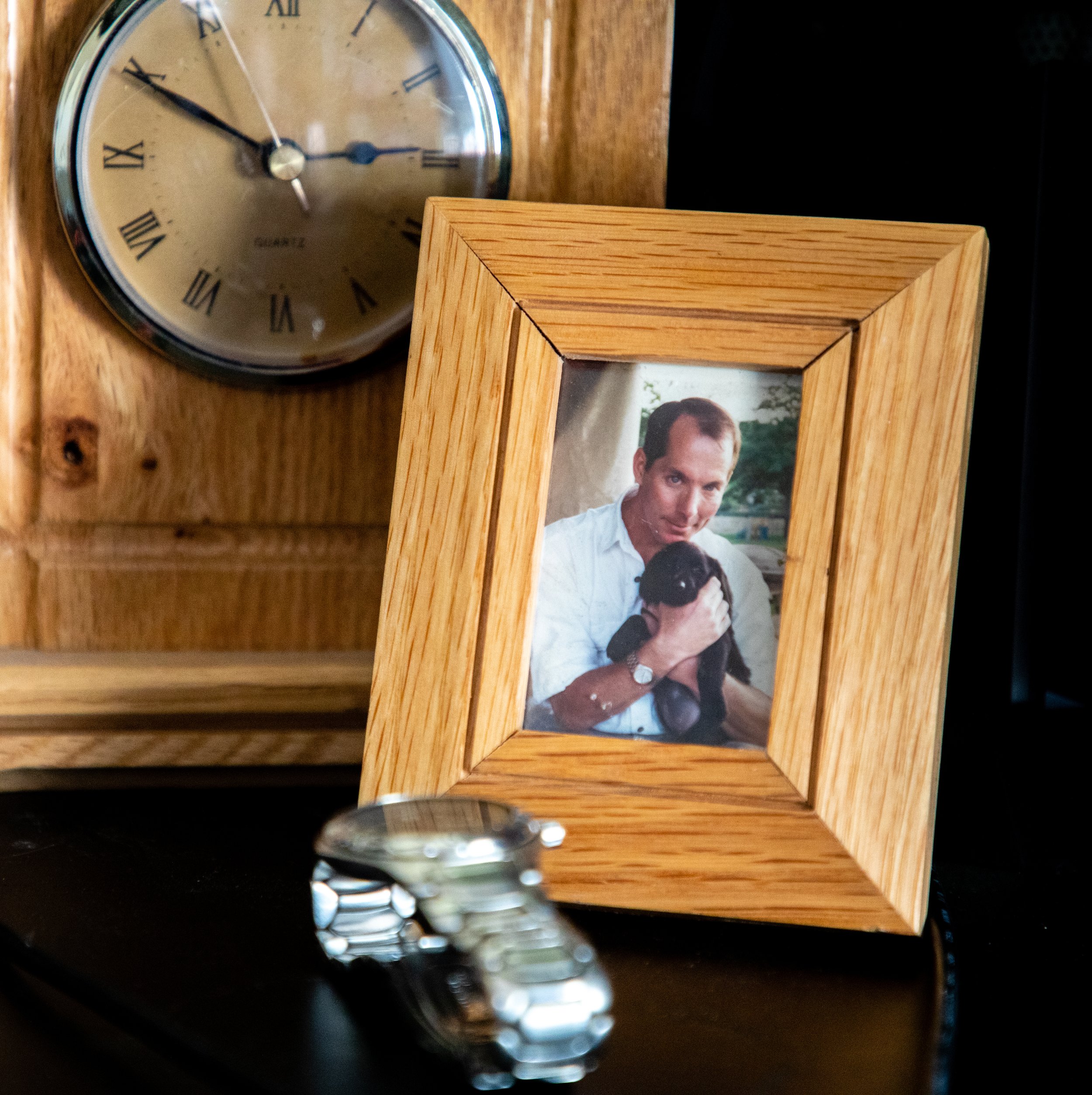 On Smith's desk rests a clock he built in Freshman Year of his High School (rear), a photo of his late father (center), and his father's watch (foreground). (Will Geschke)