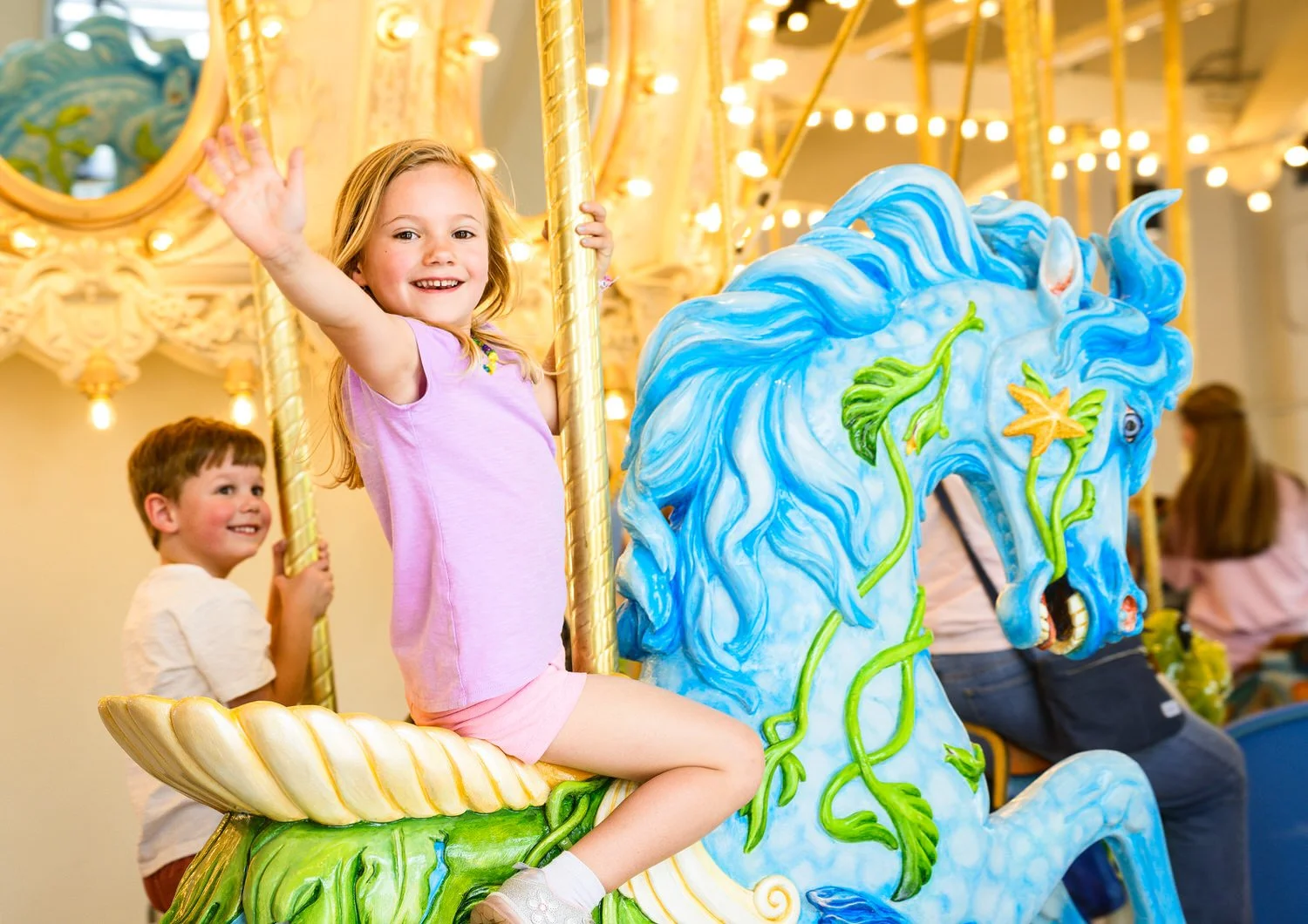 Local children ride the hand carved animals at the Carousel of Dreams at the Factory in Franklin TN