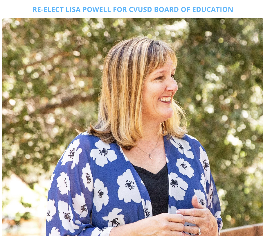 Trustee Lisa Powell wearing a blue and white floral blouse, with trees in the background.