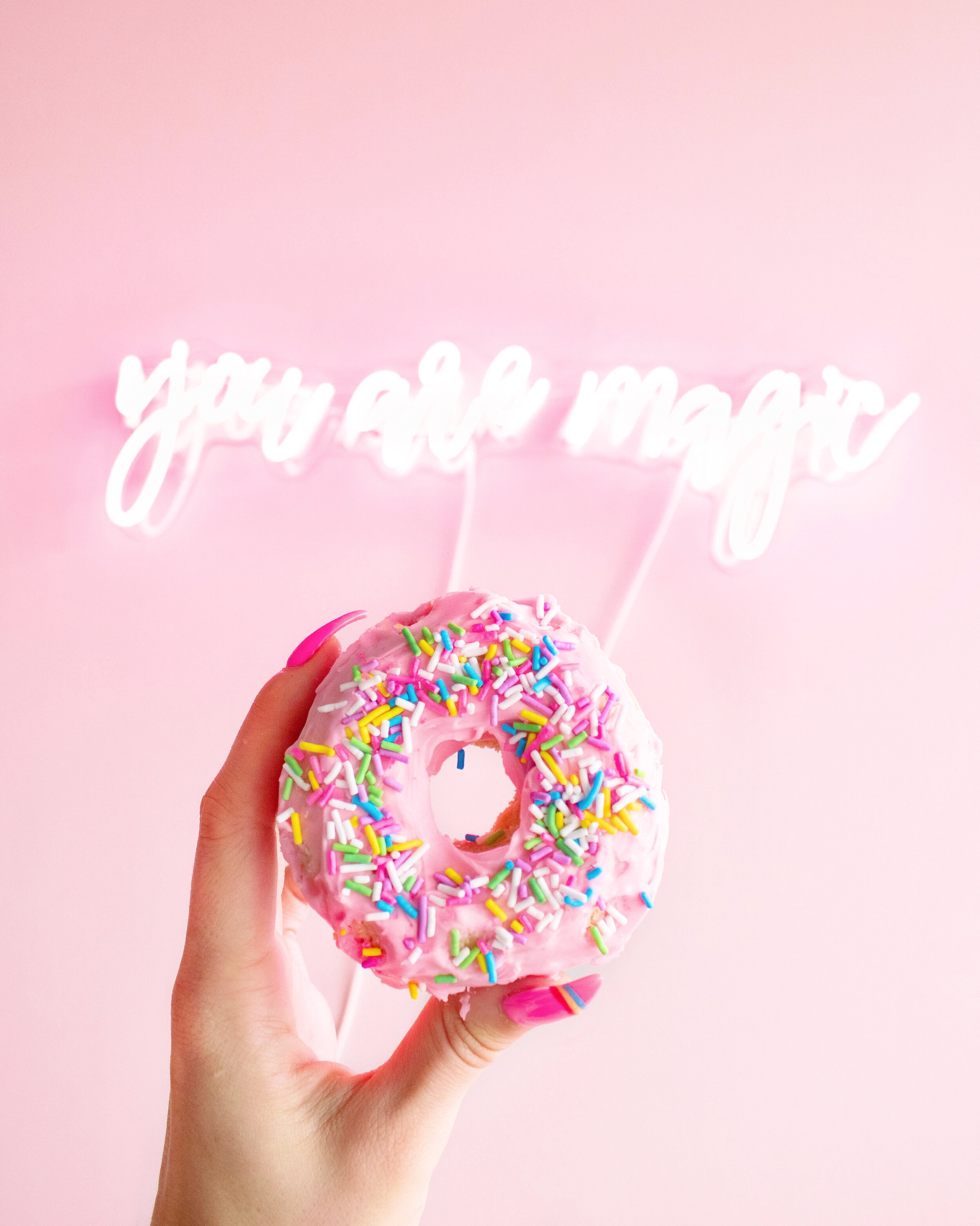 Canva - Woman Holding Donut with Sprinkles.jpg