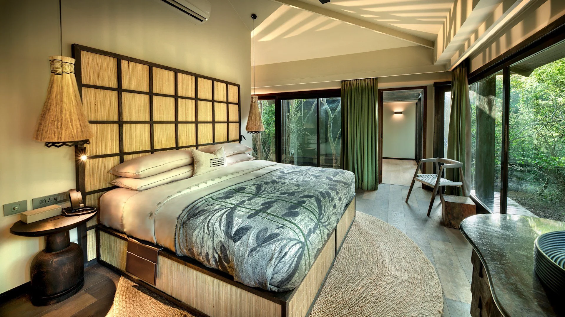 Guest Suite — Completed build
Framing the forest

The completed-suite photograph shares this palette and several signature elements, while showing a different headboard infill, exposed roof structure and furniture arrangement.