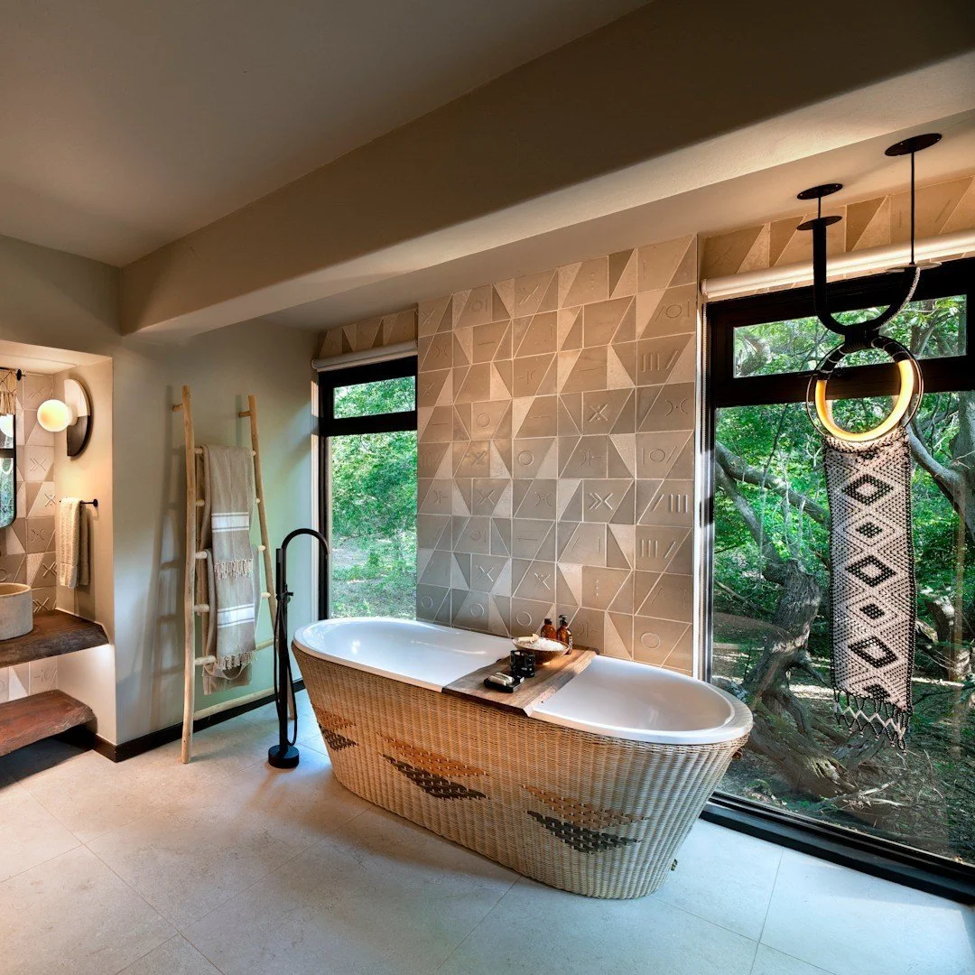 Guest Bathroom — Completed build
A shared language of pattern and texture

The completed bathroom shows related motifs from another viewpoint, with a different bath pattern and suspended feature. Glazing beside the bath opens the finished space to th