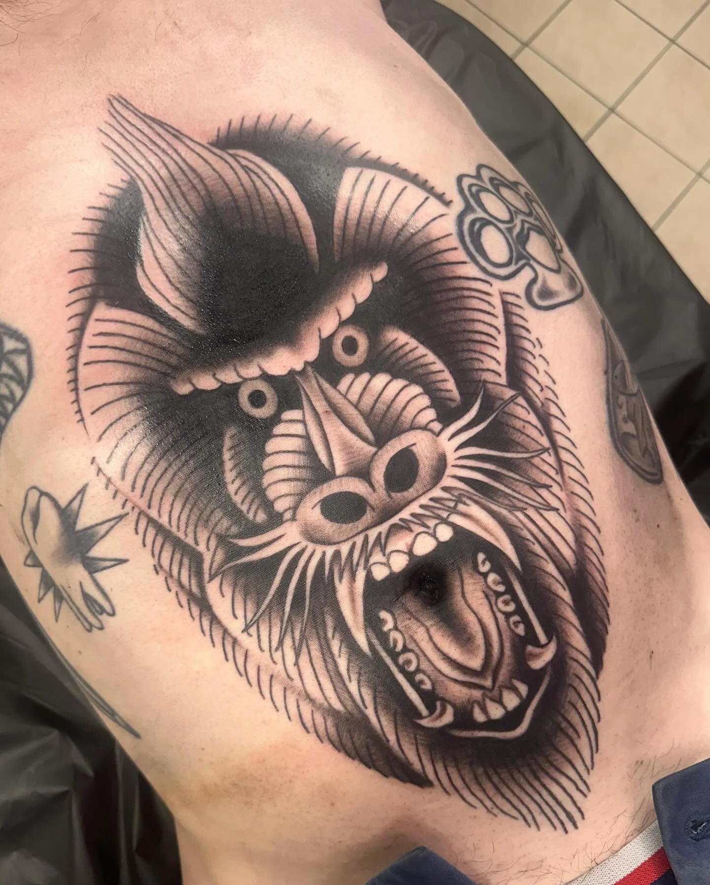 really big mandrill tattoo on my bf&rsquo;s tummy (and all up in his belly button 😱) + a couple healed ones on his legs