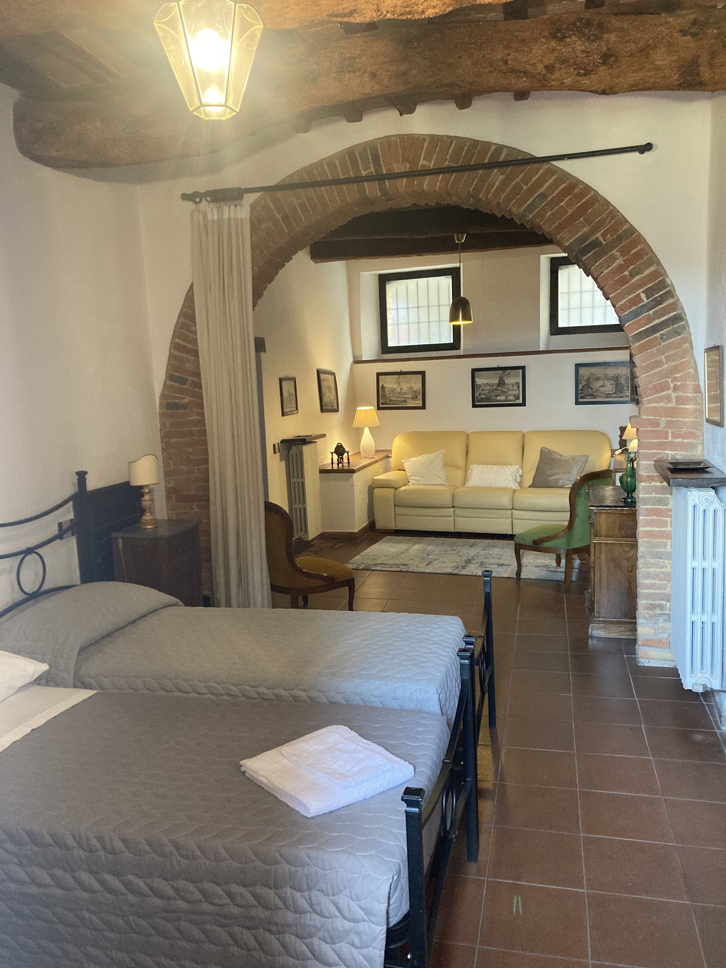 Bedroom with two separate beeds and living room