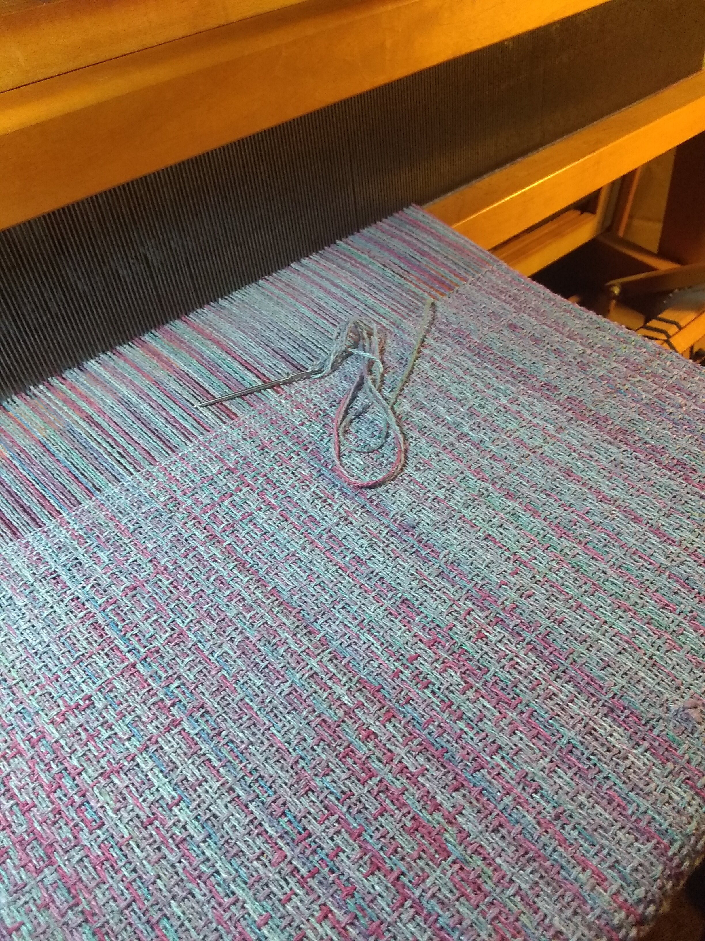 When the piece is completed I usually hemstitch each end for a finished look and a secure structure.
