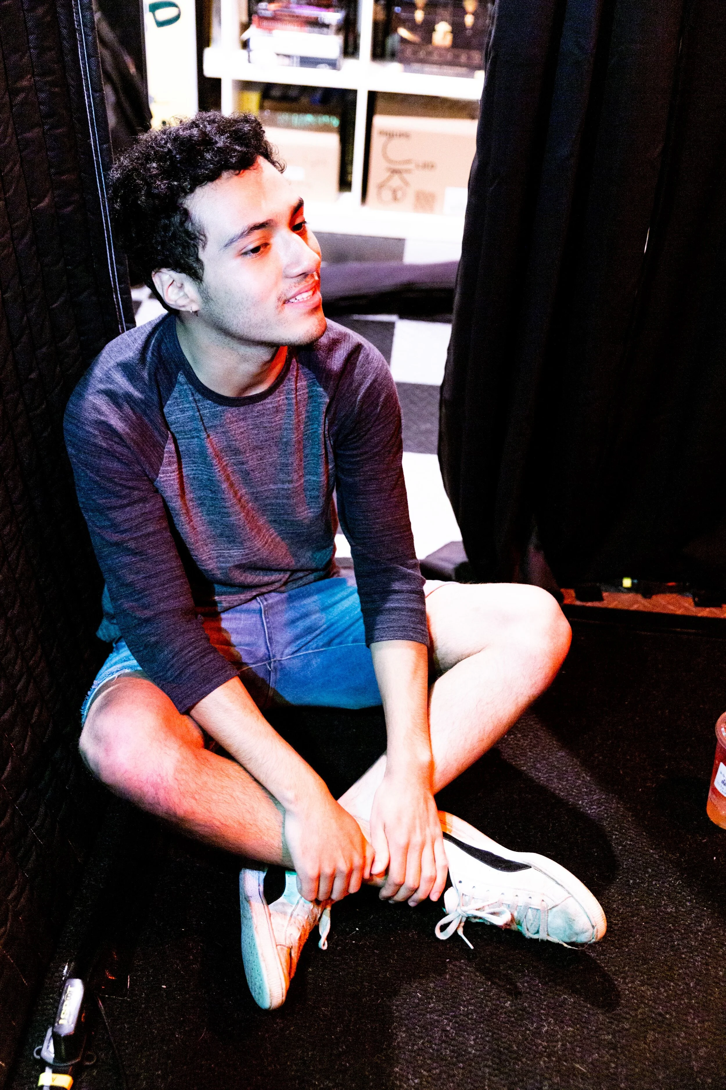 Five By Two’s Aaron Garcia sits on the ground during Evil Felipe’s live session recording in June. (Photo by Samuel Bendix)