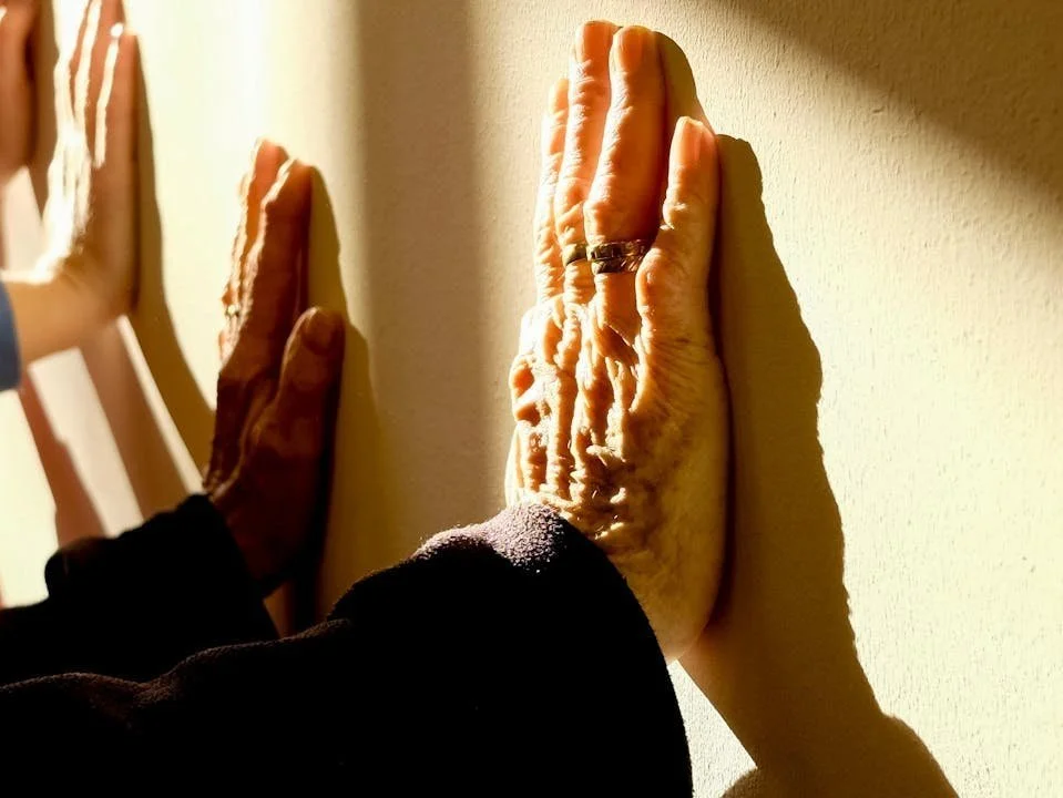 Found hands push into a yellow wall