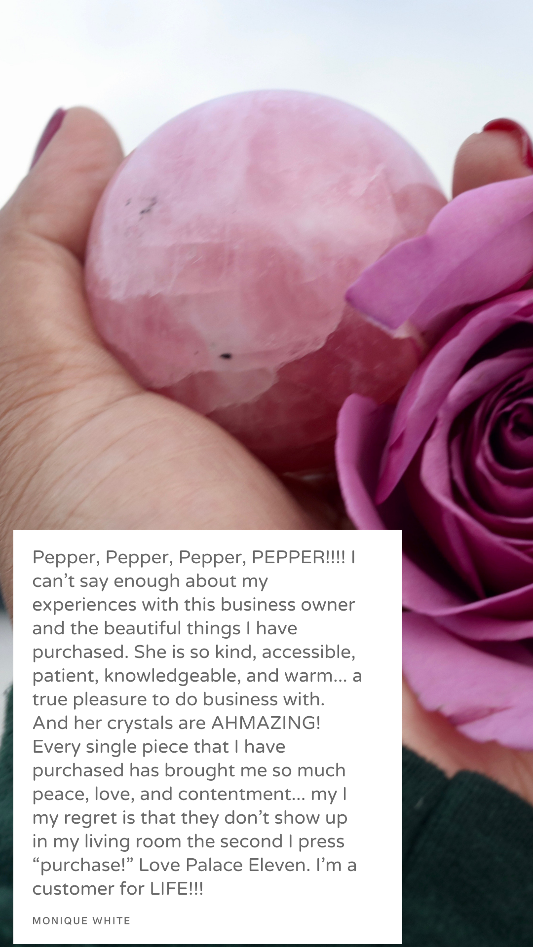 Pink rose and a pink crystal ball in a person's hand with a white background.