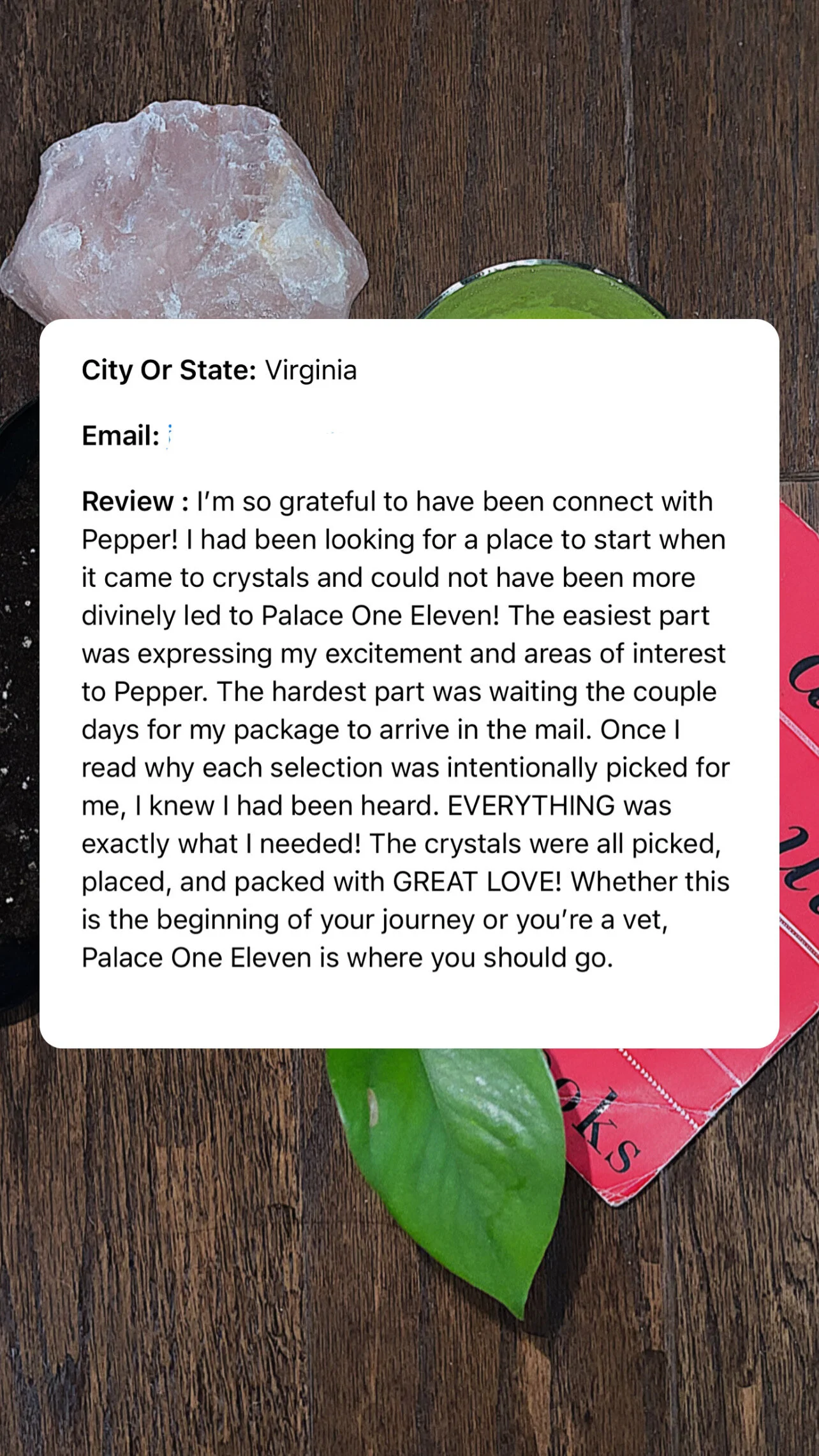 A close-up photo of a pink Himalayan salt rock, a green leaf, and part of a red and black Valentine's Day card on a wooden surface, with an overlay of a customer review.