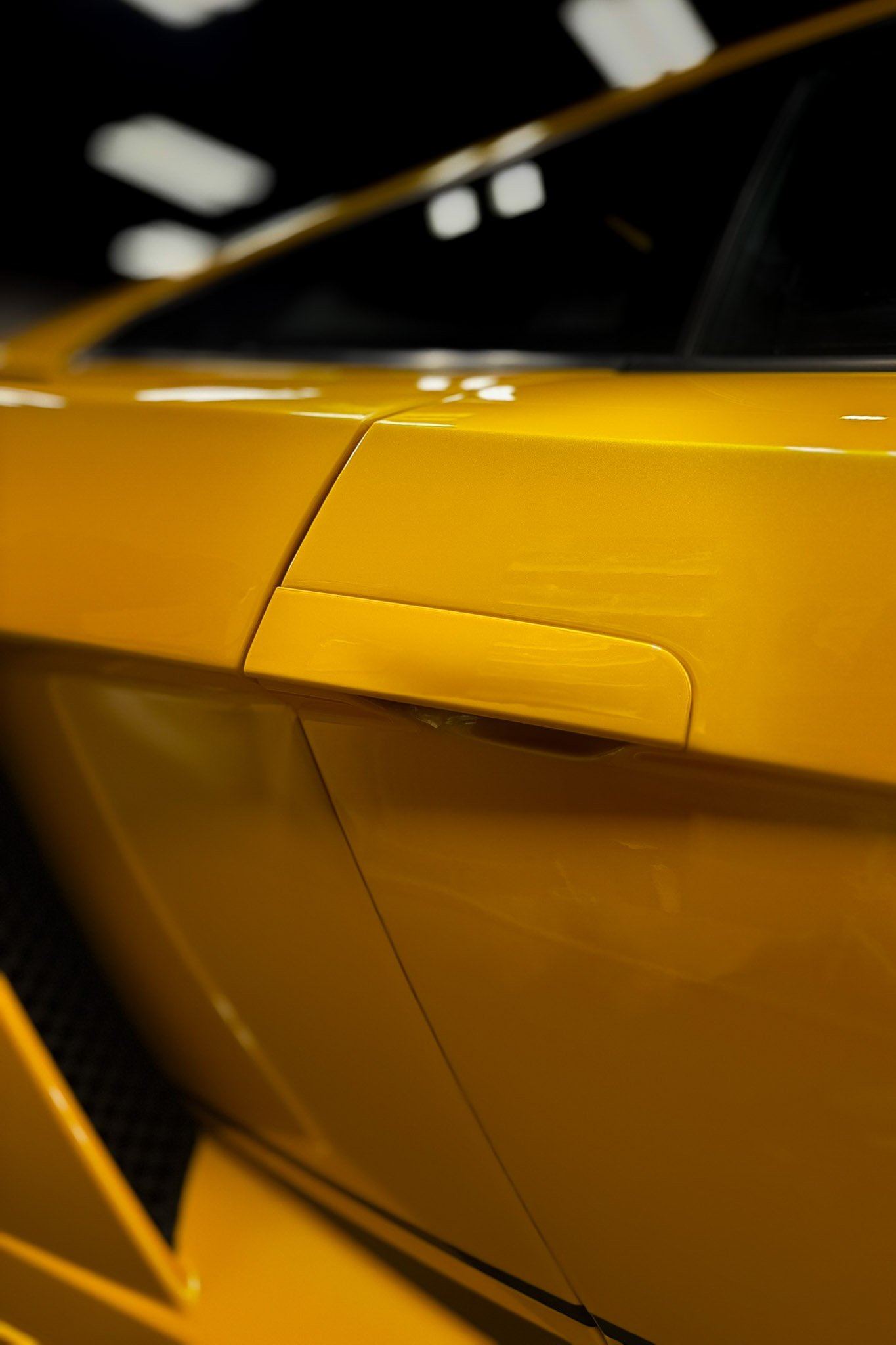Side profile of a yellow exotic sports car with paint protection film applied to the door and fender - EIGHTYNINE VWS PPF service in Little Elm, TX
