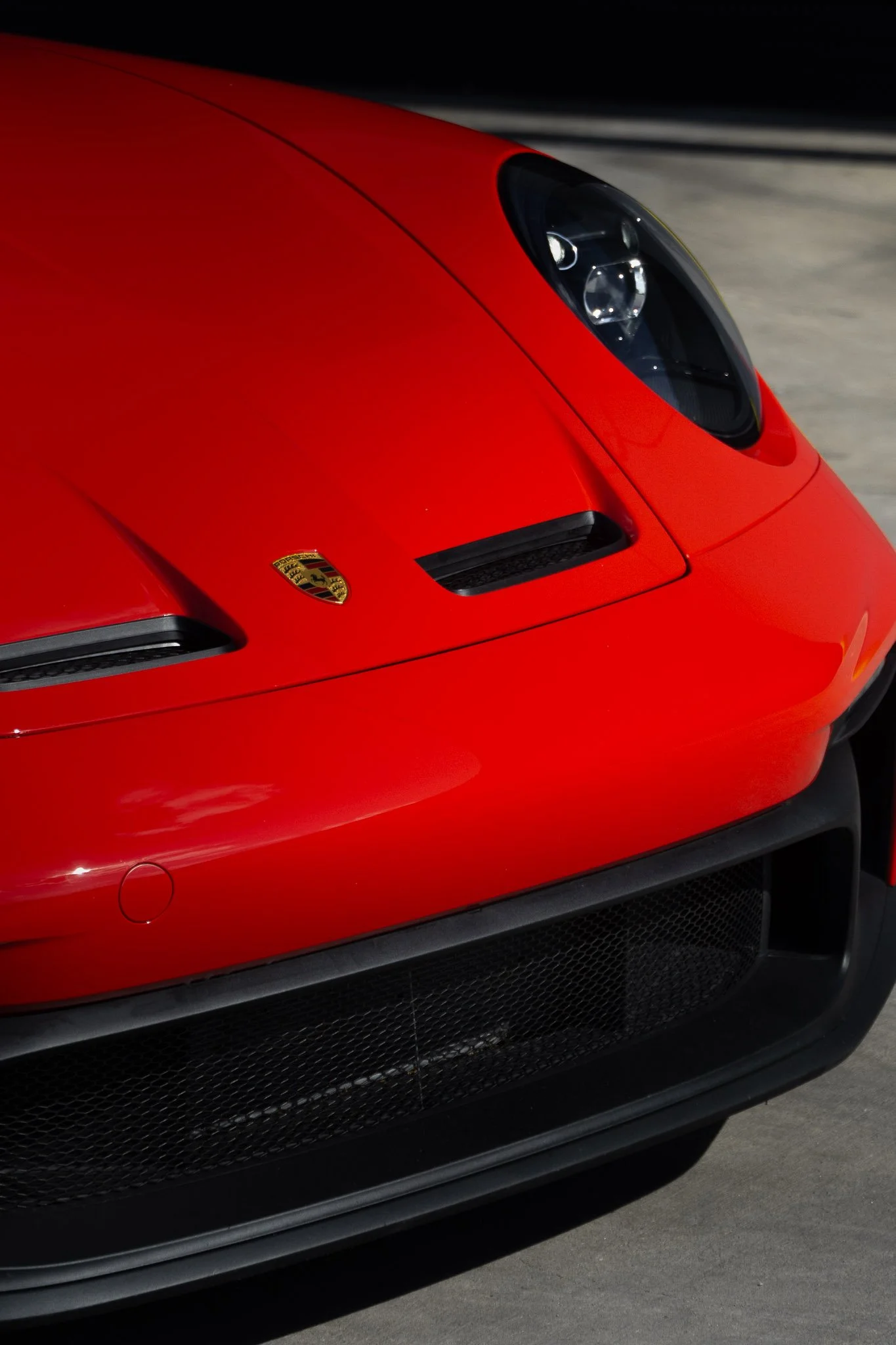 Front end view of a red Porsche 911 with clear paint protection film applied to the hood and headlights - EIGHTYNINE VWS PPF installation in Little Elm, TX