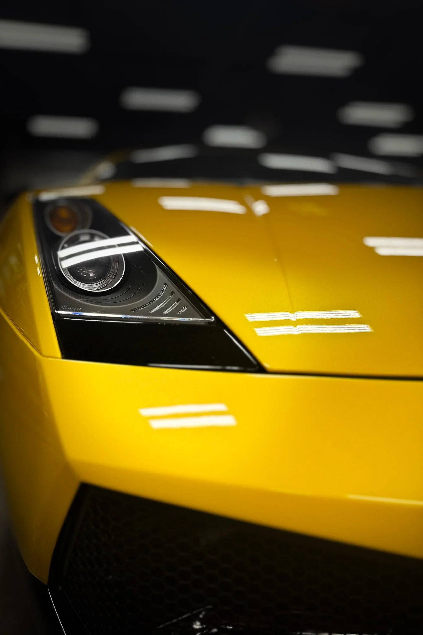 Front hood and headlight of a yellow exotic sports car with clear paint protection film applied - EIGHTYNINE VWS PPF installation in Little Elm, TX