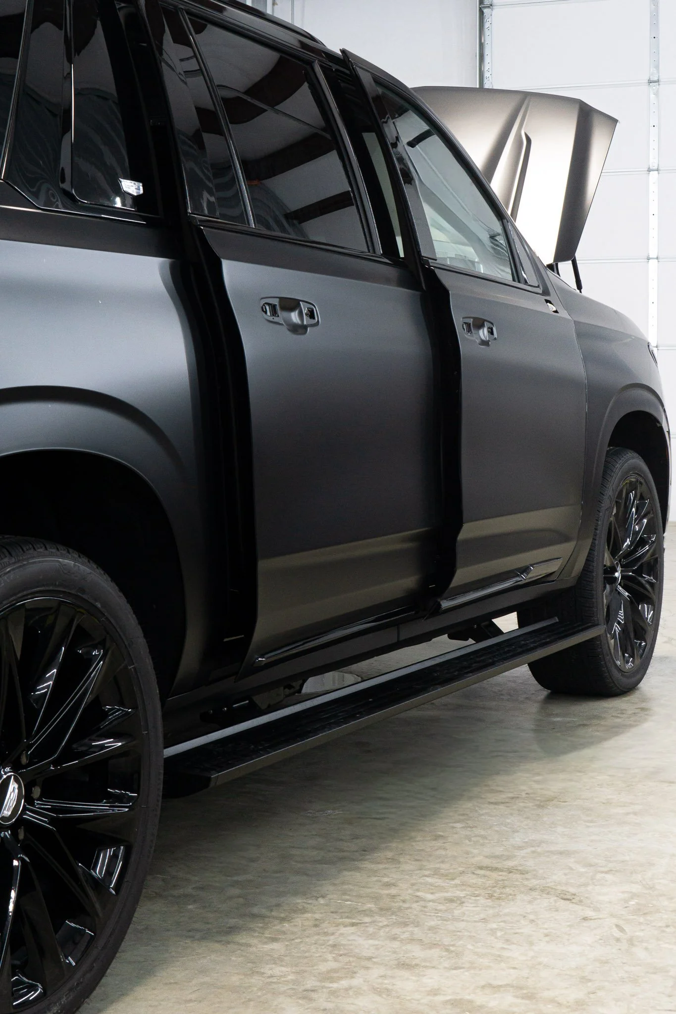 Front three-quarter view of a black Cadillac Escalade with hood open after paint protection film installation - EIGHTYNINE VWS PPF service in Little Elm, TX