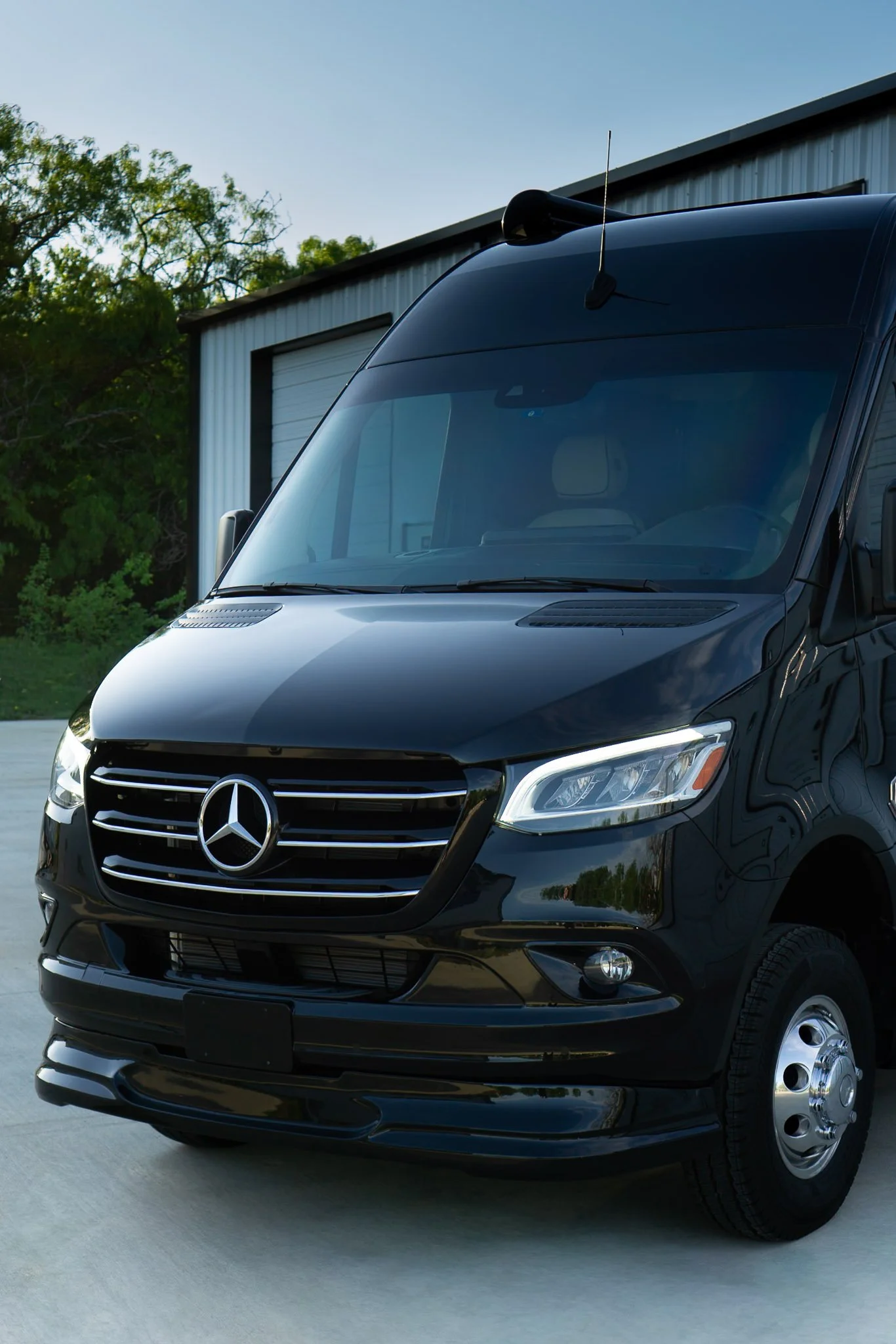 Front grille of a black Mercedes-Benz van with the Mercedes star emblem visible, protected by paint protection film - EIGHTYNINE VWS PPF service in Little Elm, TX
