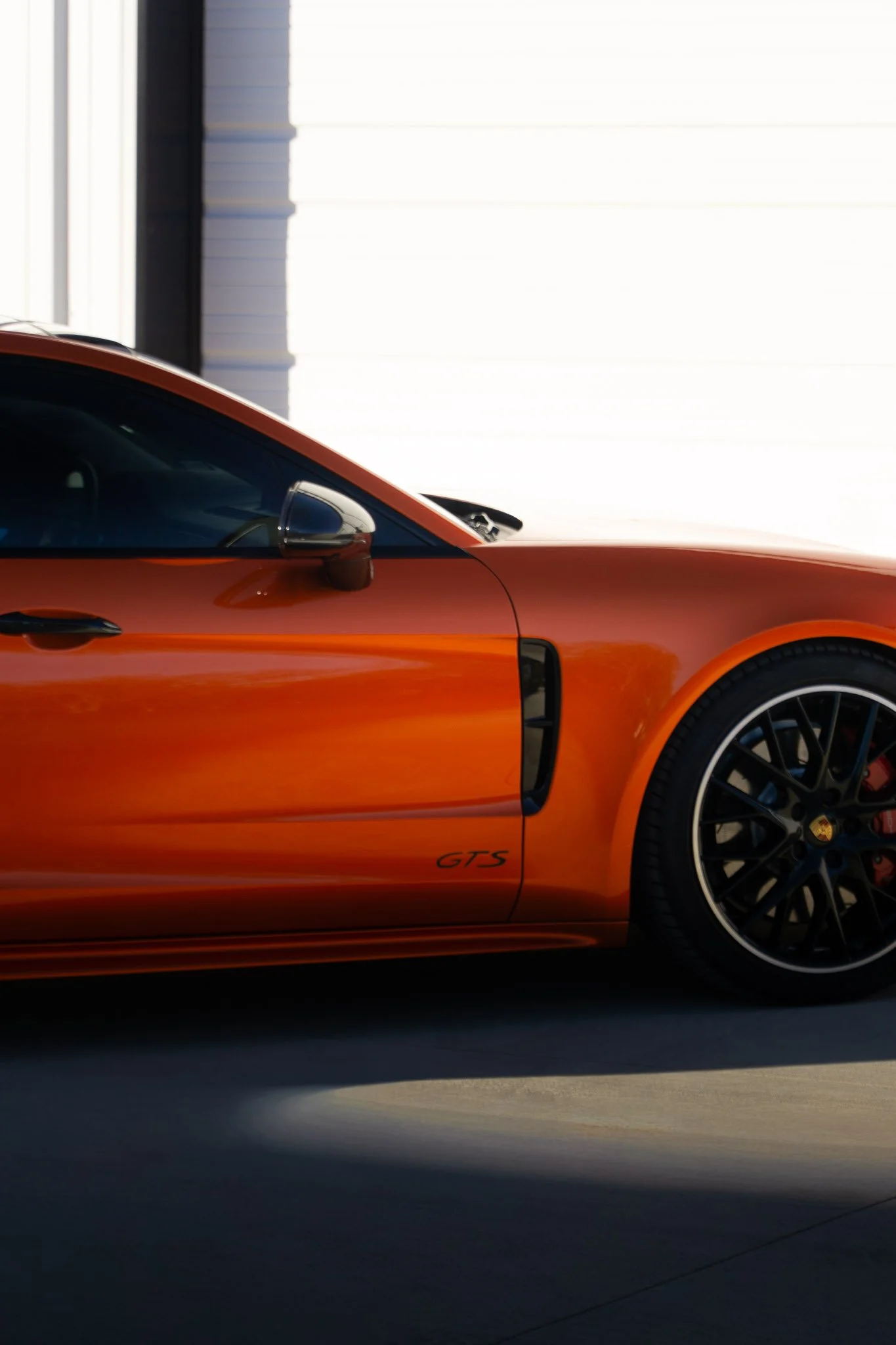 Front three-quarter view of an orange Porsche 718 Cayman GTS with color change paint protection film, finished by EIGHTYNINE VWS in Little Elm, TX