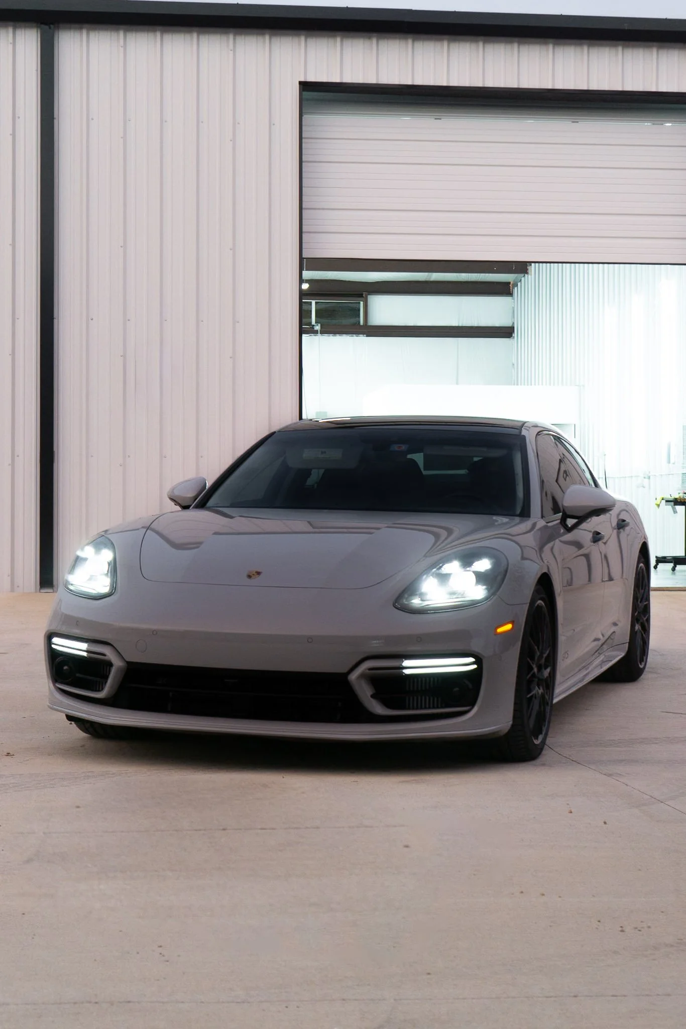 Silver Porsche Panamera parked inside the EIGHTYNINE VWS studio, part of the completed vehicle wrap and PPF results gallery in Little Elm, TX