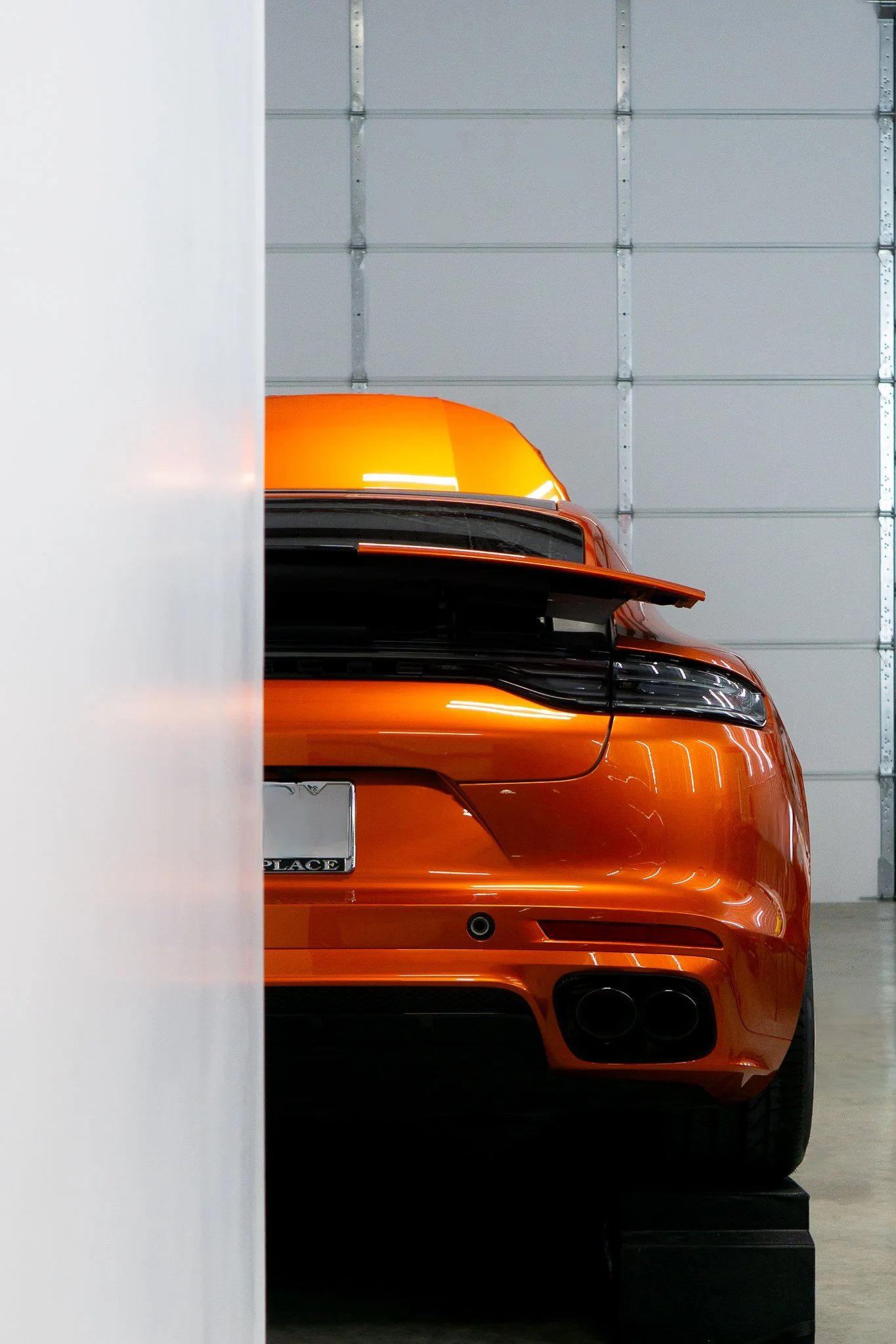 Front three-quarter view of an orange Porsche 718 Cayman GTS with color change paint protection film freshly installed at EIGHTYNINE VWS's studio in Little Elm, TX