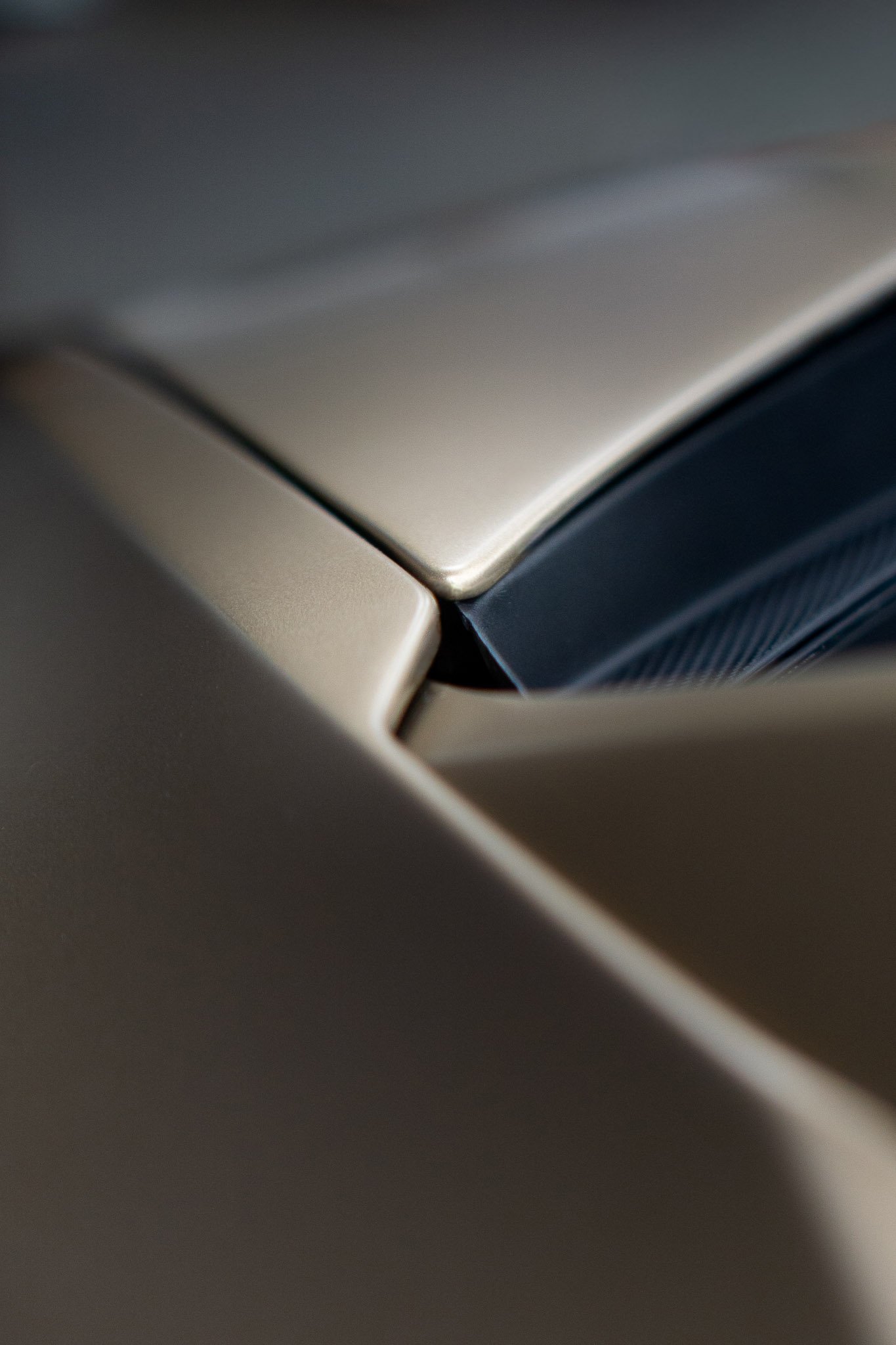 Close-up detail of a champagne-tan vehicle's A-pillar and roofline showing a seamless paint protection film edge - precision PPF installation by EIGHTYNINE VWS in Little Elm, TX