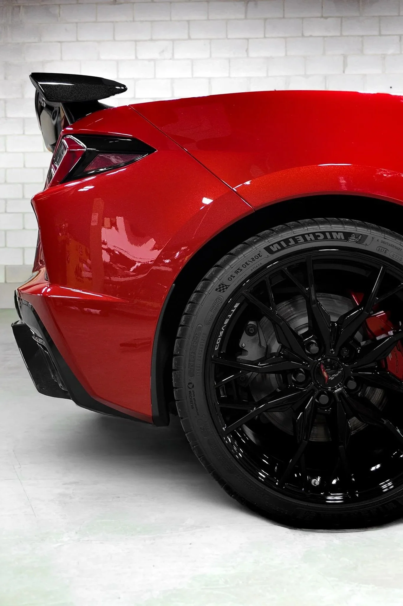 Rear wheel, fender, and spoiler of a red sports car protected with paint protection film - EIGHTYNINE VWS PPF installation in Little Elm, TX