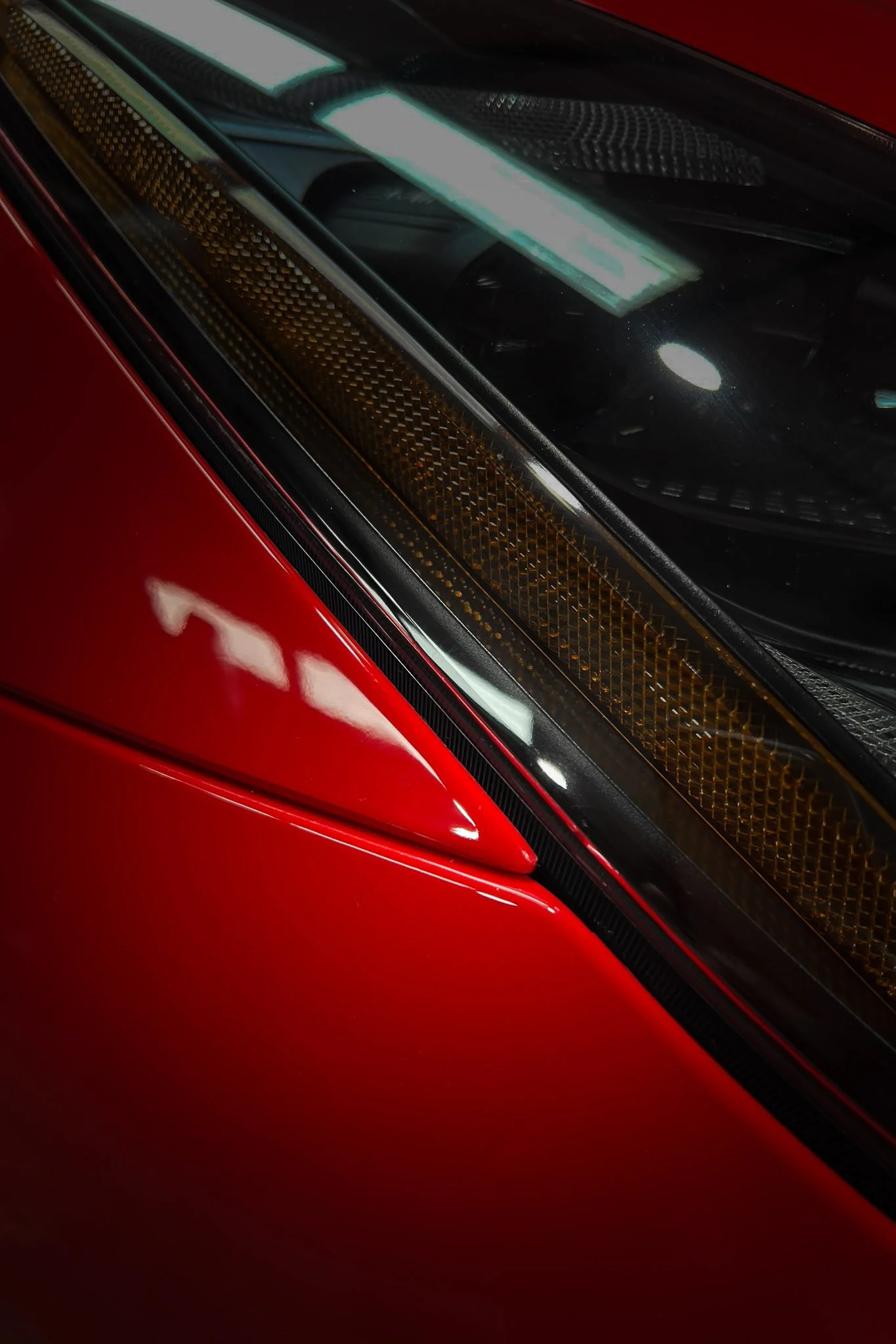 Close-up of a dark red vehicle's window pillar with paint protection film installed - EIGHTYNINE VWS PPF service in Little Elm, TX