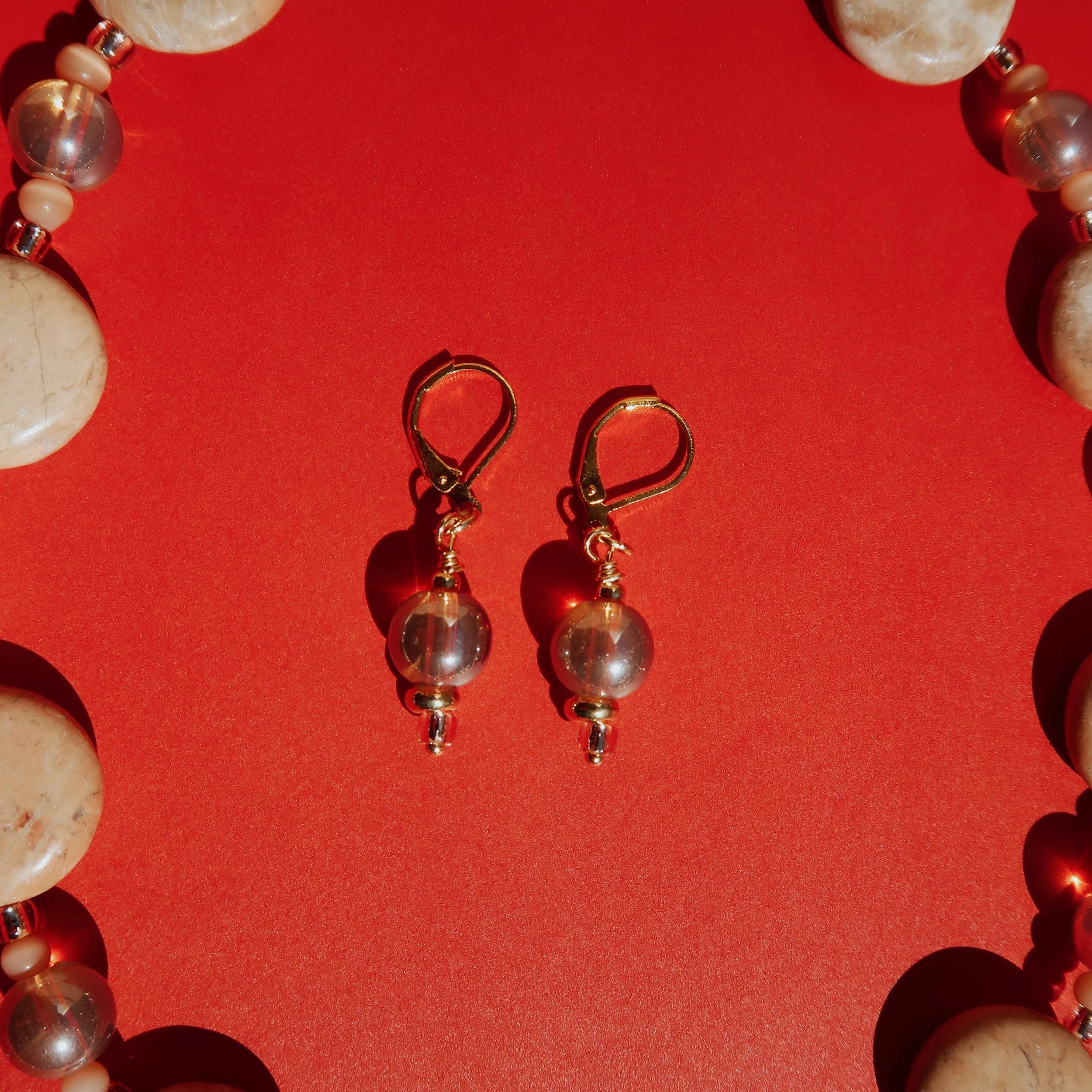ChampagneEarringsonRed_Sq.JPG