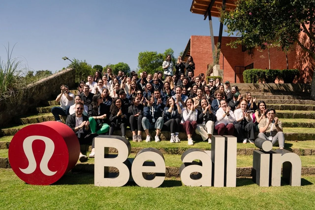 lululemon Mexico team gathered outdoors around large Be all in letters