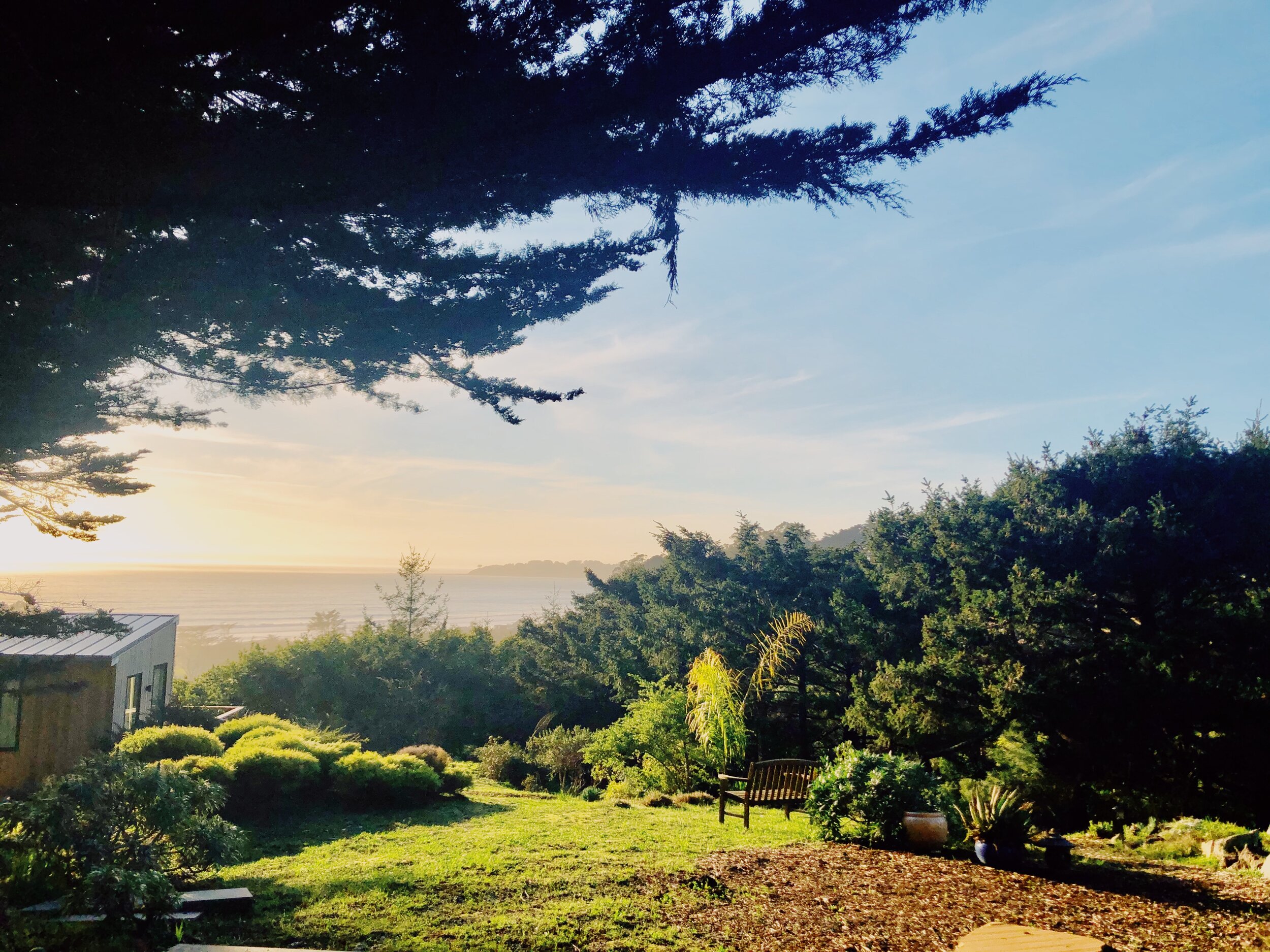 Coastal garden sunset at Kenko Retreat, a luxury vacation rental in Stinson Beach, Northern California, with ocean views, landscaped grounds, and scenic Marin coastline near San Francisco.