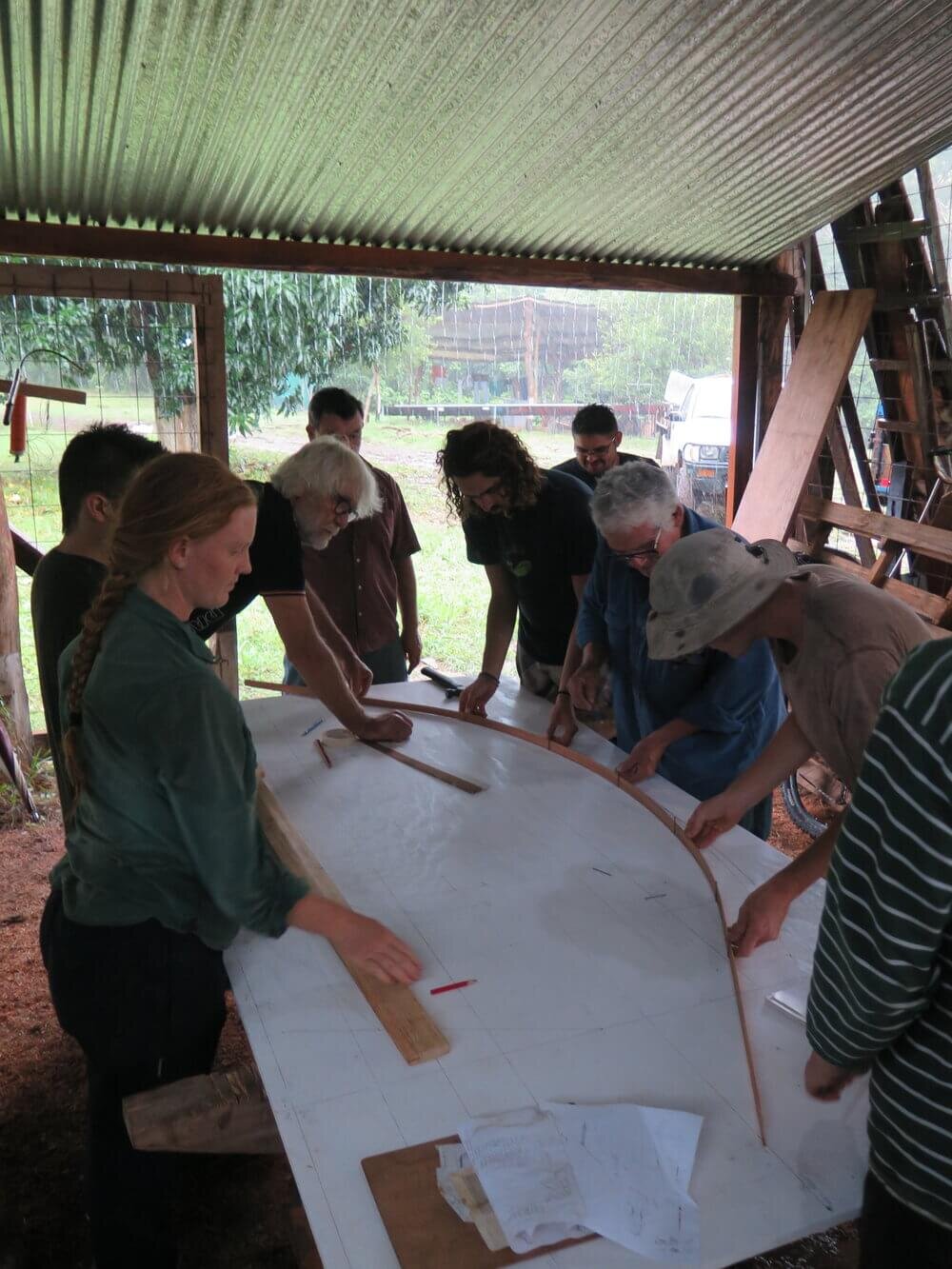 Drawing out a curve using a thin strip of batten as a guide.