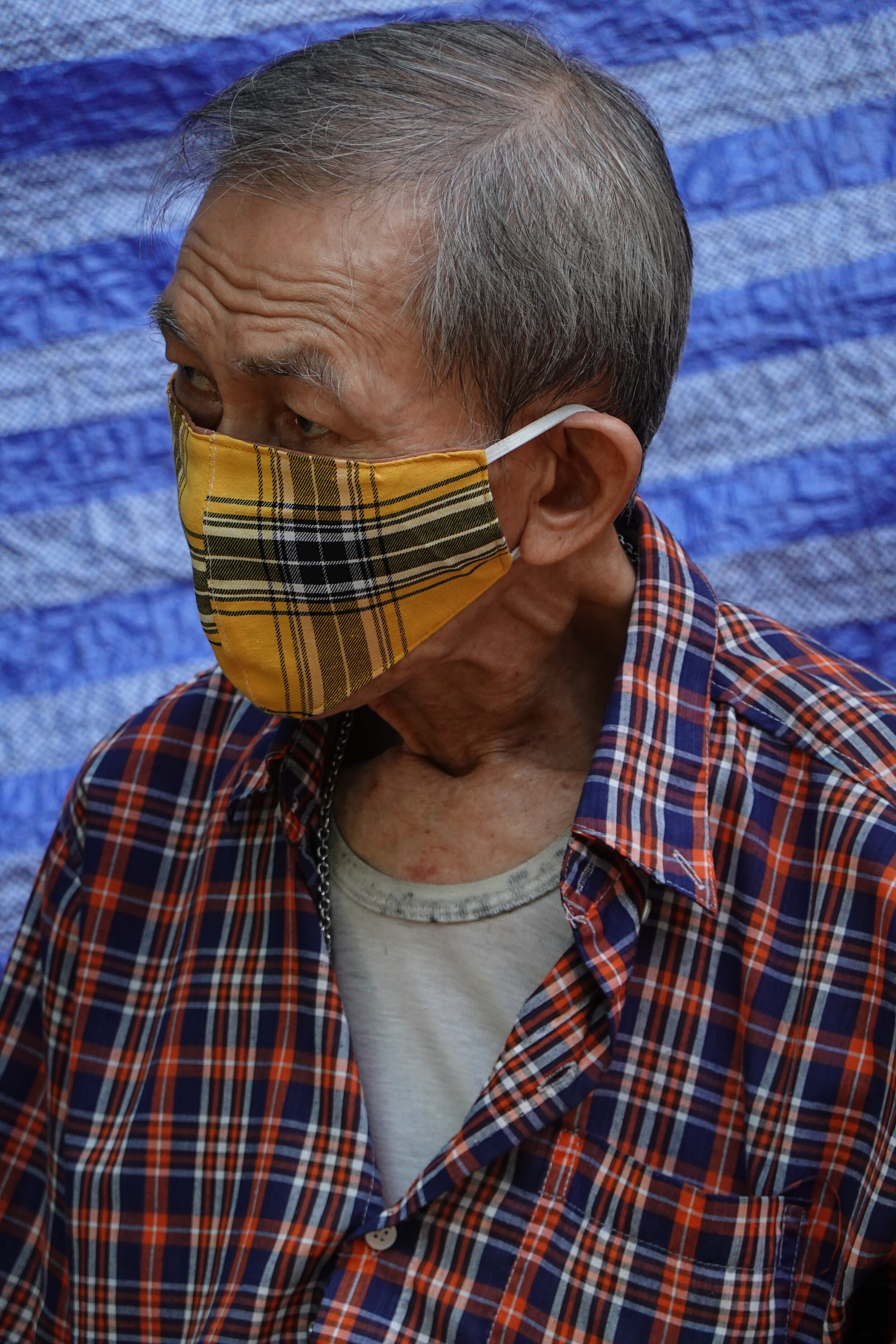 Man waiting for the local bus. Chinatown, Bangkok. May 2020